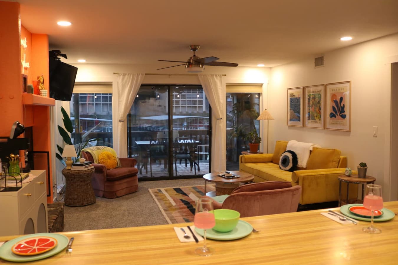 An inviting open living area with modern furnishings and direct access to a private balcony with stunning lake views.