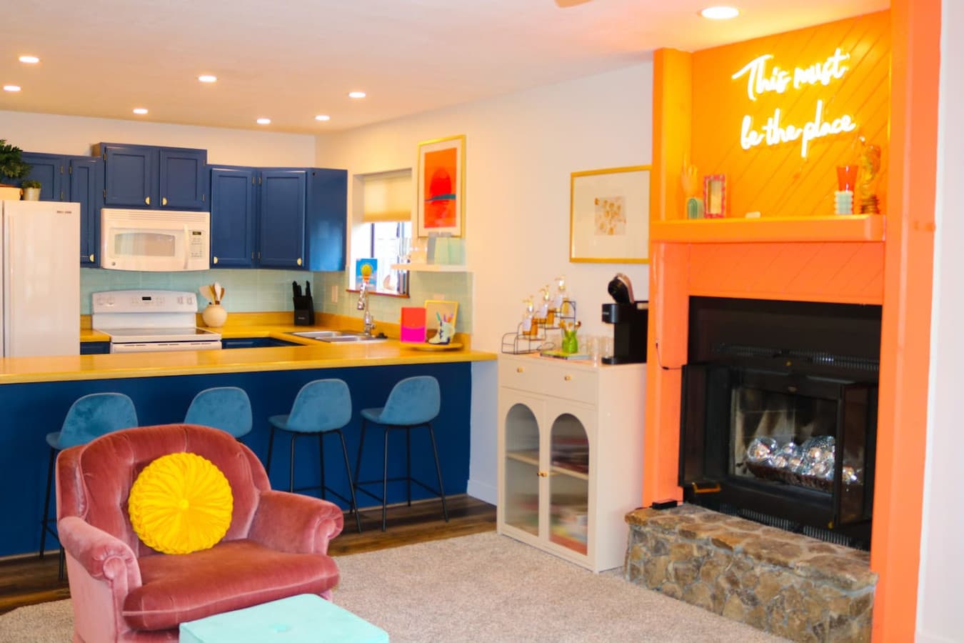 Relax and unwind in this vibrant living space, complete with a cozy fireplace and a cheerful vibe.