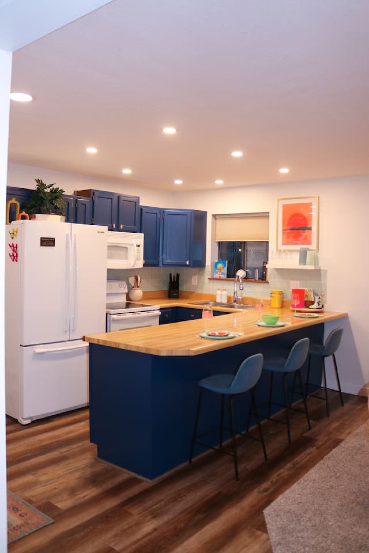 Cook up something special in the fully equipped kitchen with bold blue cabinets and modern appliances.
