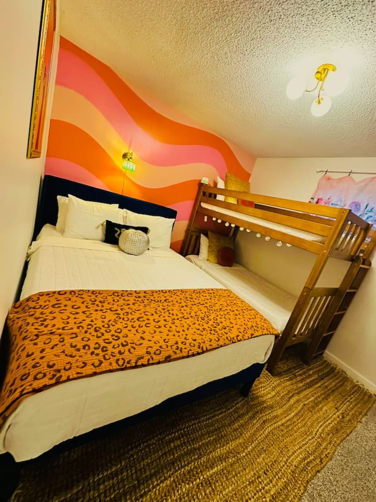 Fun and functional sleeping arrangements a queen bed and and a bunk bed with 2 twin beds perfect for families or group getaways.