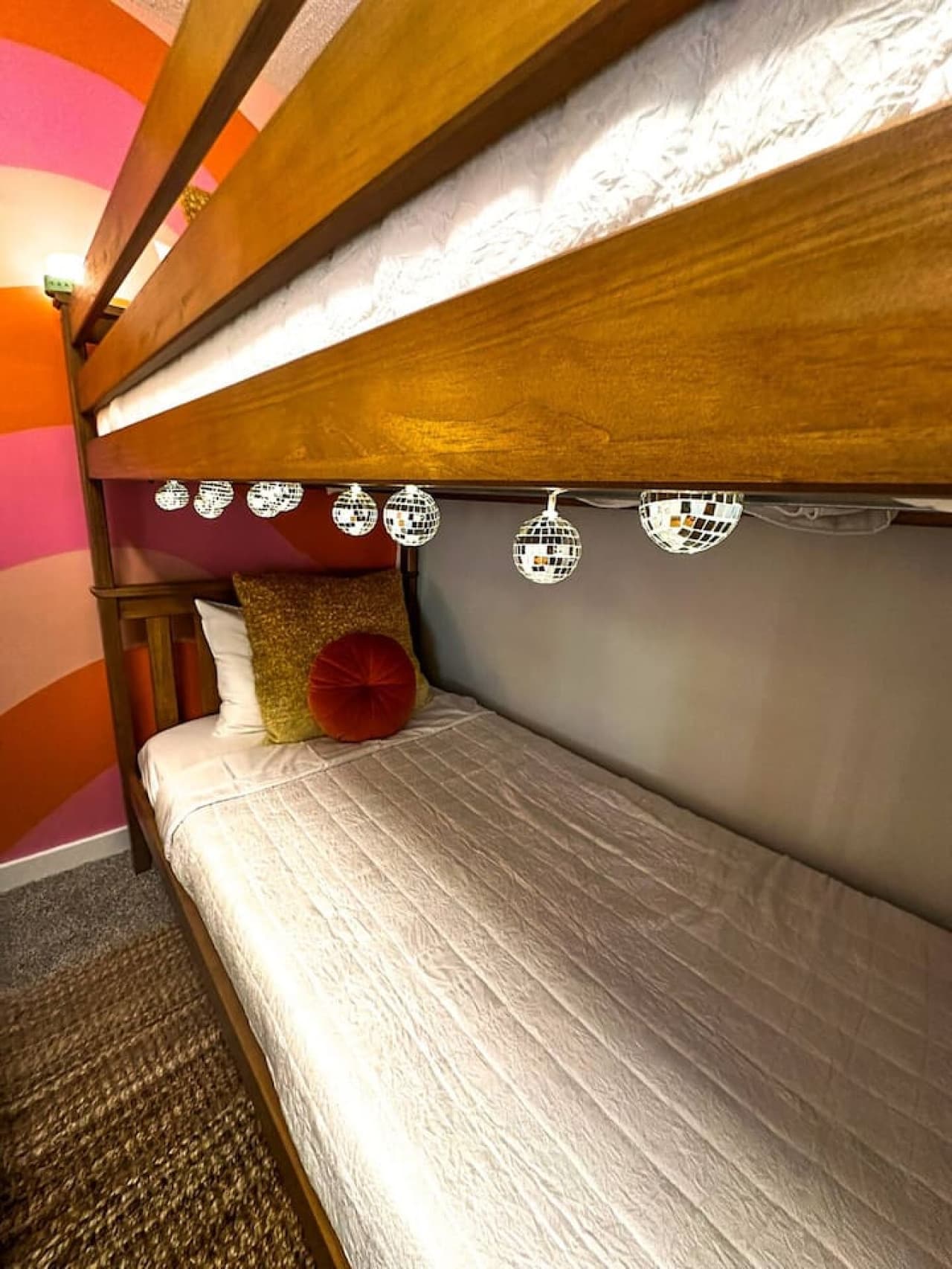 Add a touch of sparkle to your stay – this cozy twin bunk bed setup is perfect for kids or fun-loving adults!