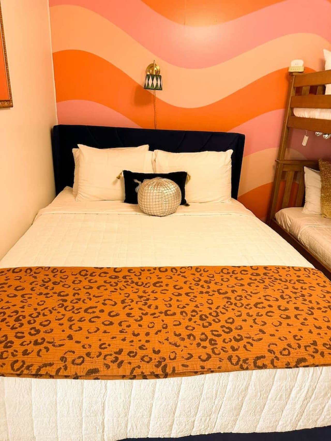 Relax in this vibrant bedroom featuring a unique wave-inspired design, plush bedding, and a stylish atmosphere for restful nights.