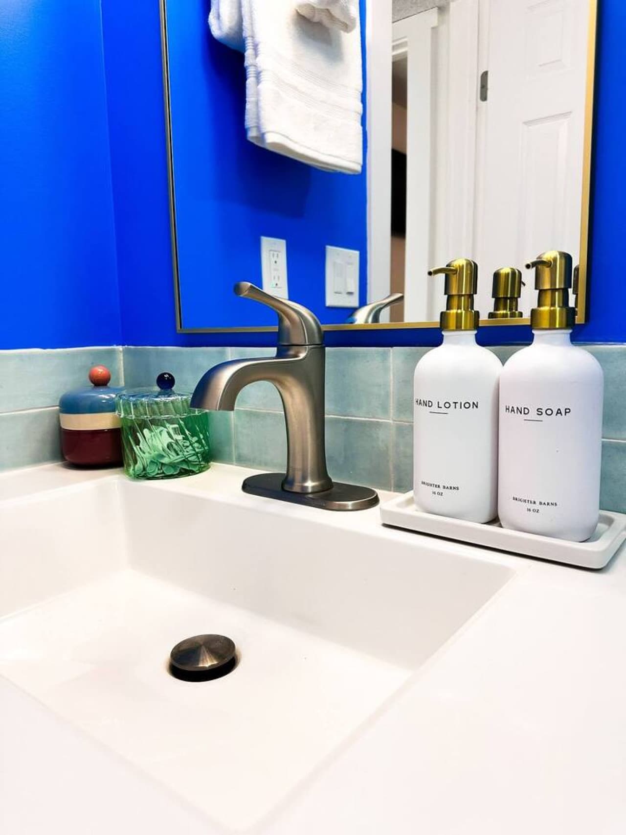 Modern meets bold – a sleek sink area with vibrant accents and thoughtful amenities.