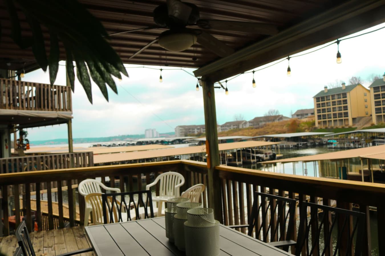 Relax and unwind under the covered deck with panoramic views of the marina and lake.