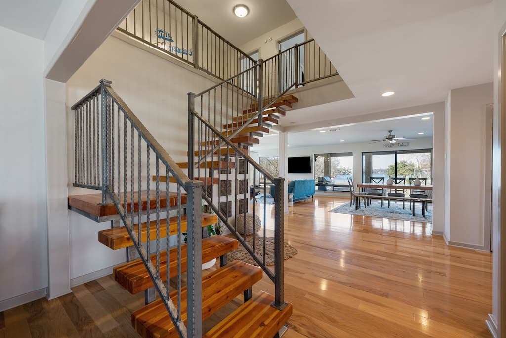 Stairs leading to 4 bedrooms and 3 baths upstairs
