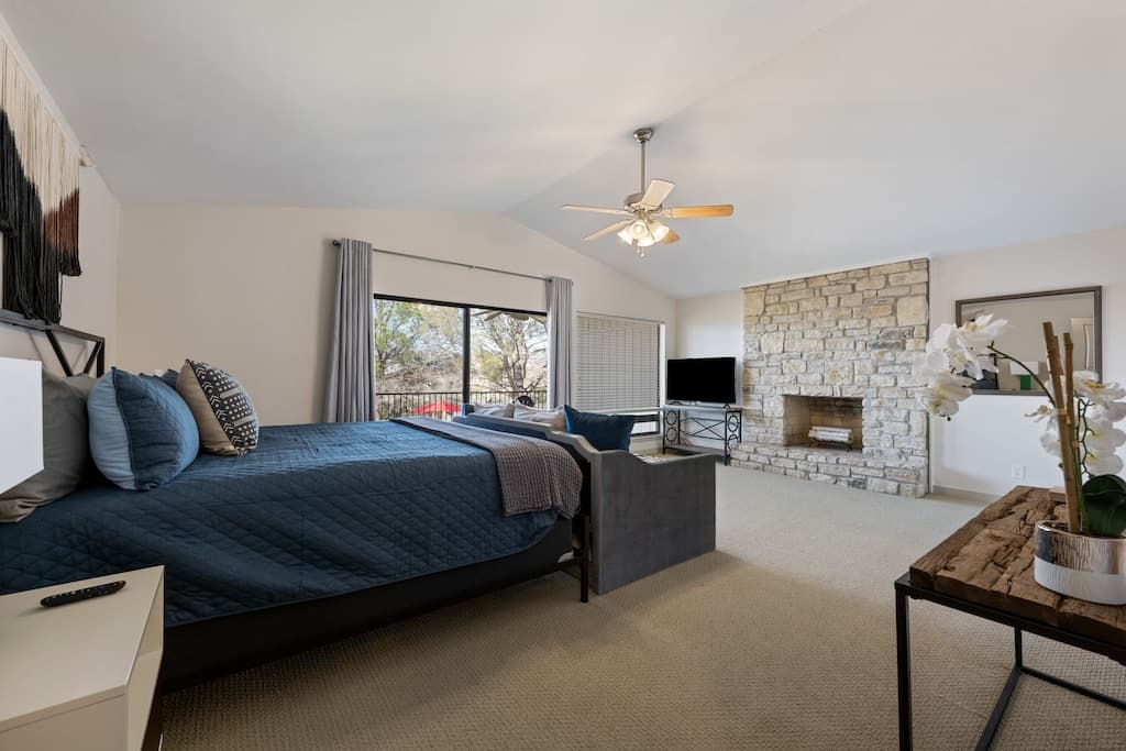 King bedroom 1 -  woodburning fireplace, smart TV, full bath and balcony access