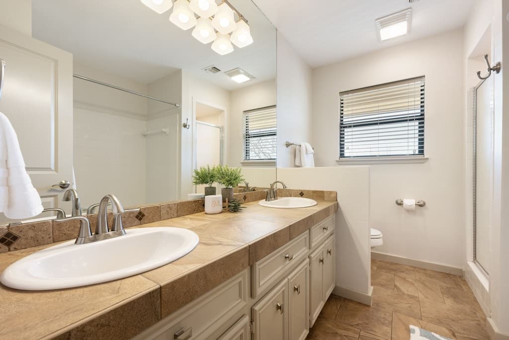 Full bath in the upstairs hallway. Stand up shower and separate tub