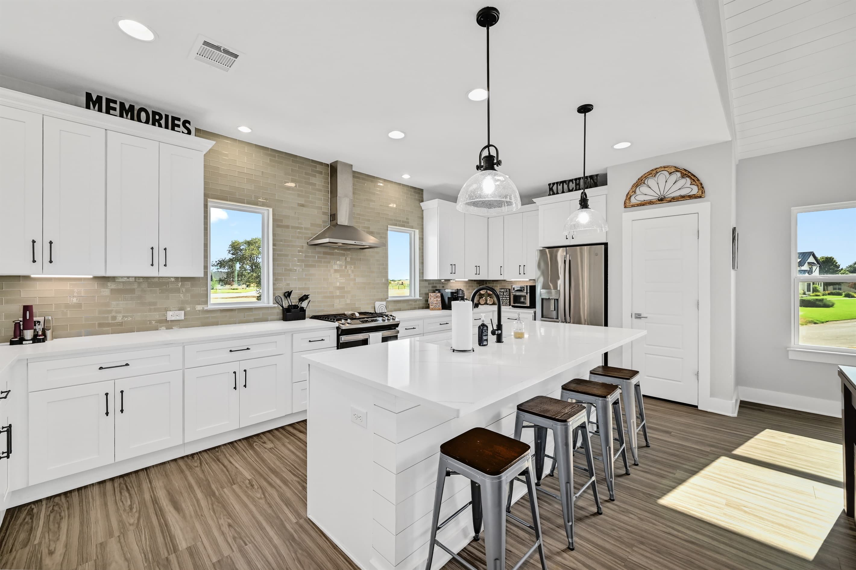 Kitchen with large counter and stools