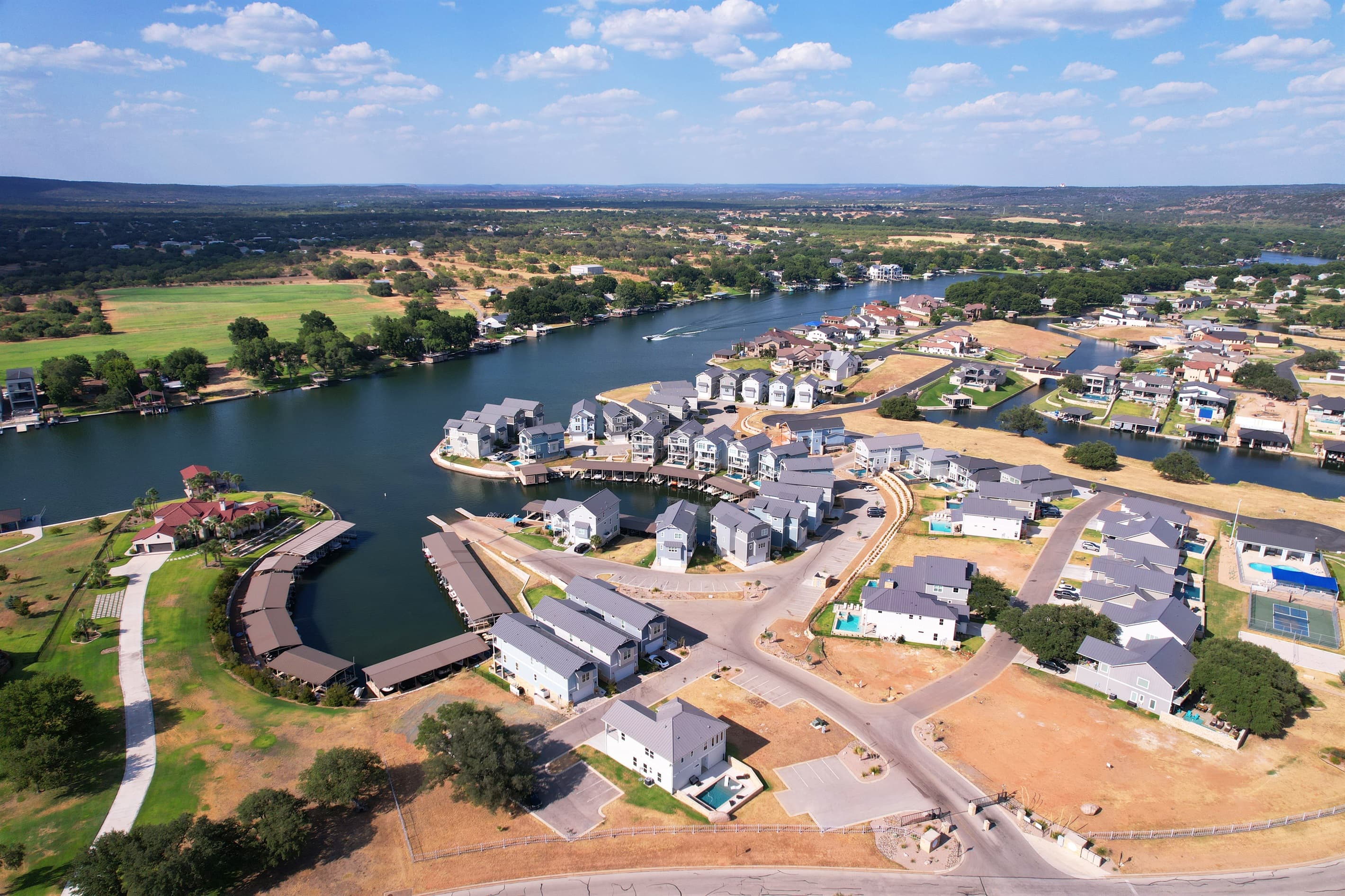 Aerial view of home showing proximity to Lake LBJ and marina