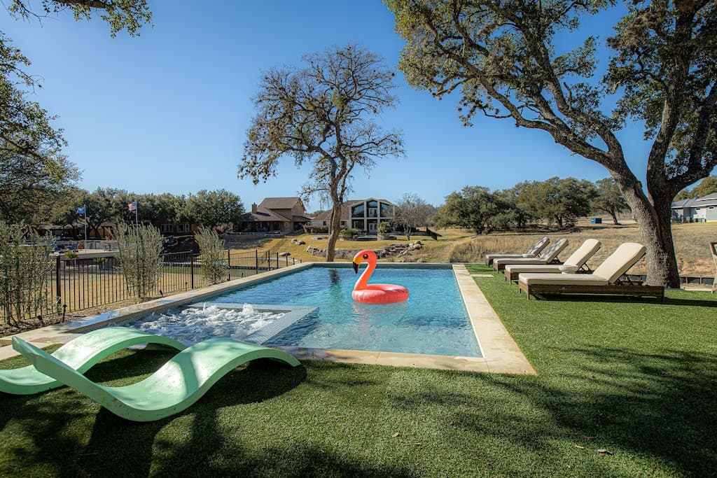 Pool area with astroturf. Plenty of room to play cornhole