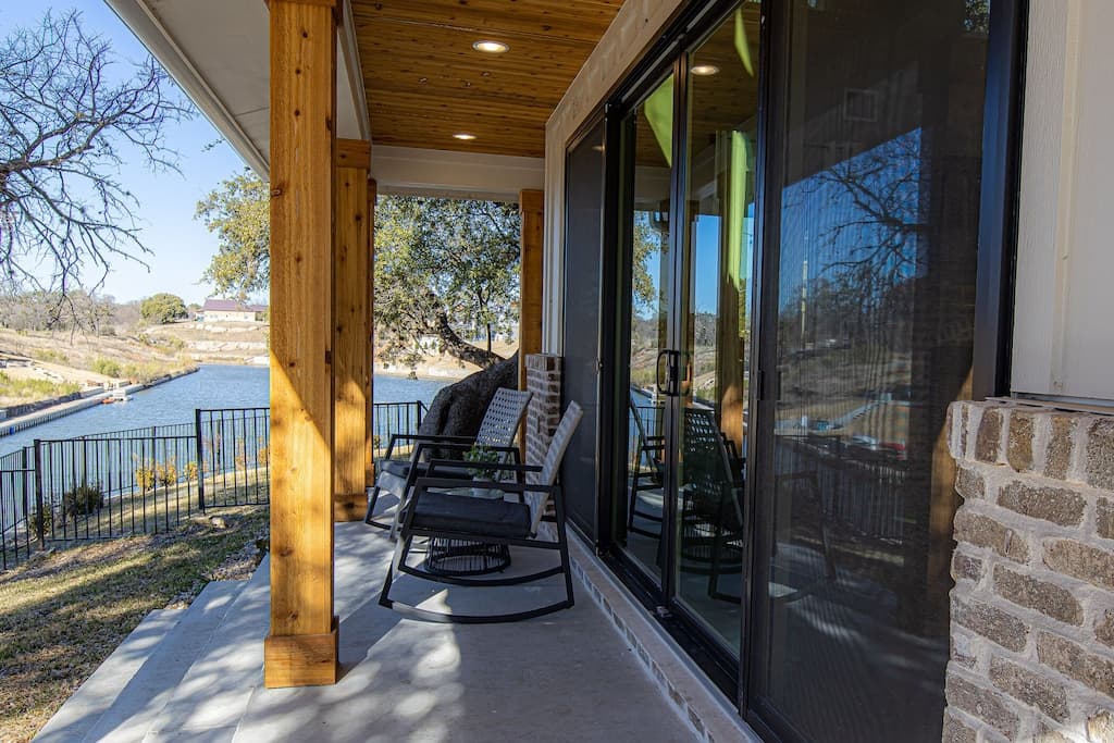 Rocking chairs on the porch with a view of the canal