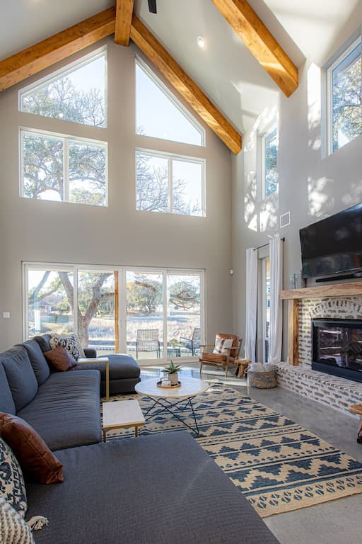Great room with high vaulted ceilings and a fireplace