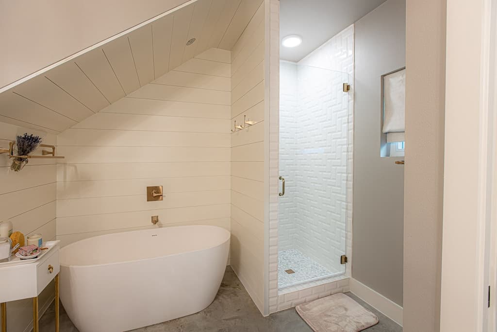 Primary bathroom with stand up shower, double sinks, and soaking tub