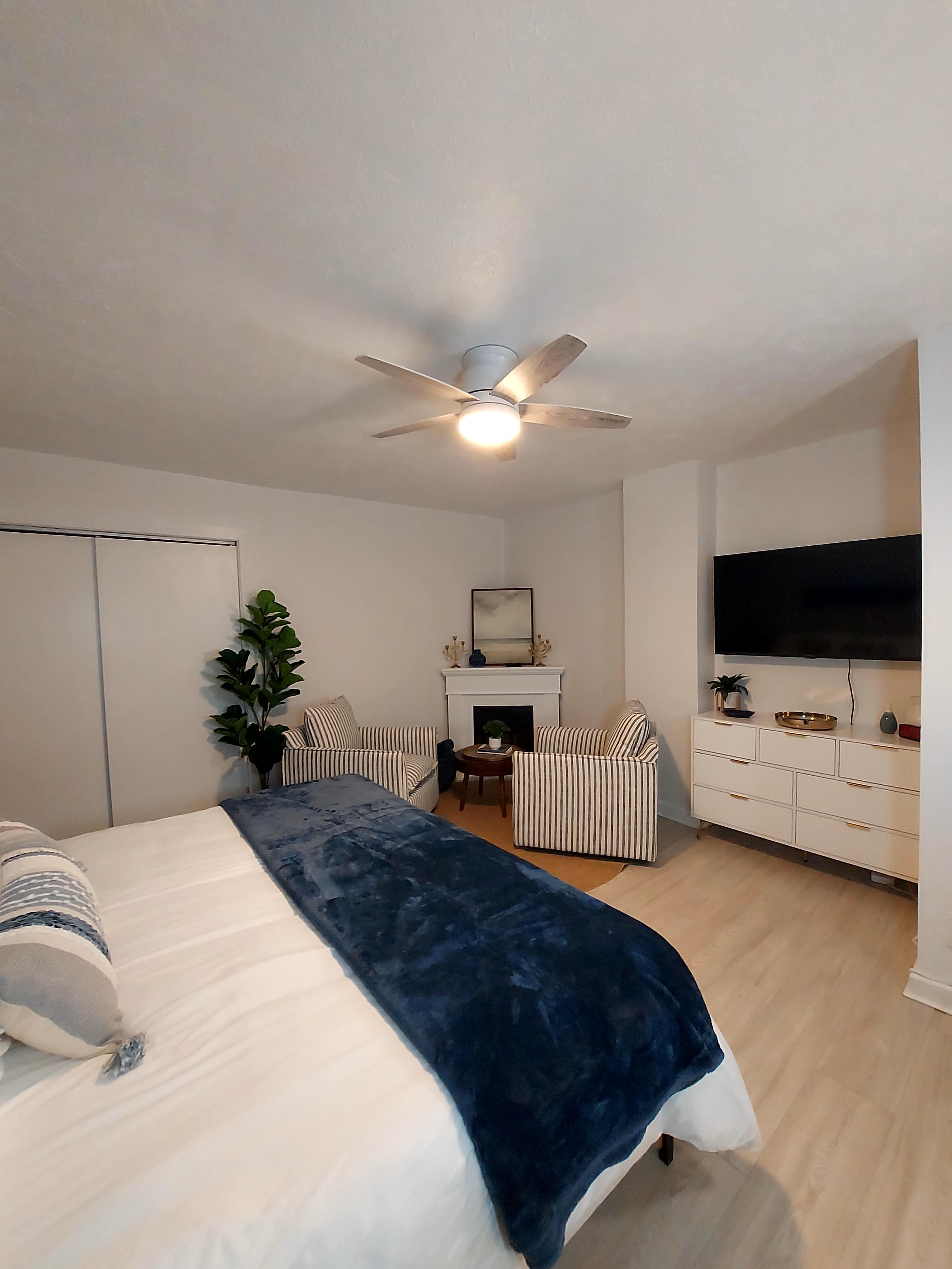 Master suite fireplace and couples seating, with TV.