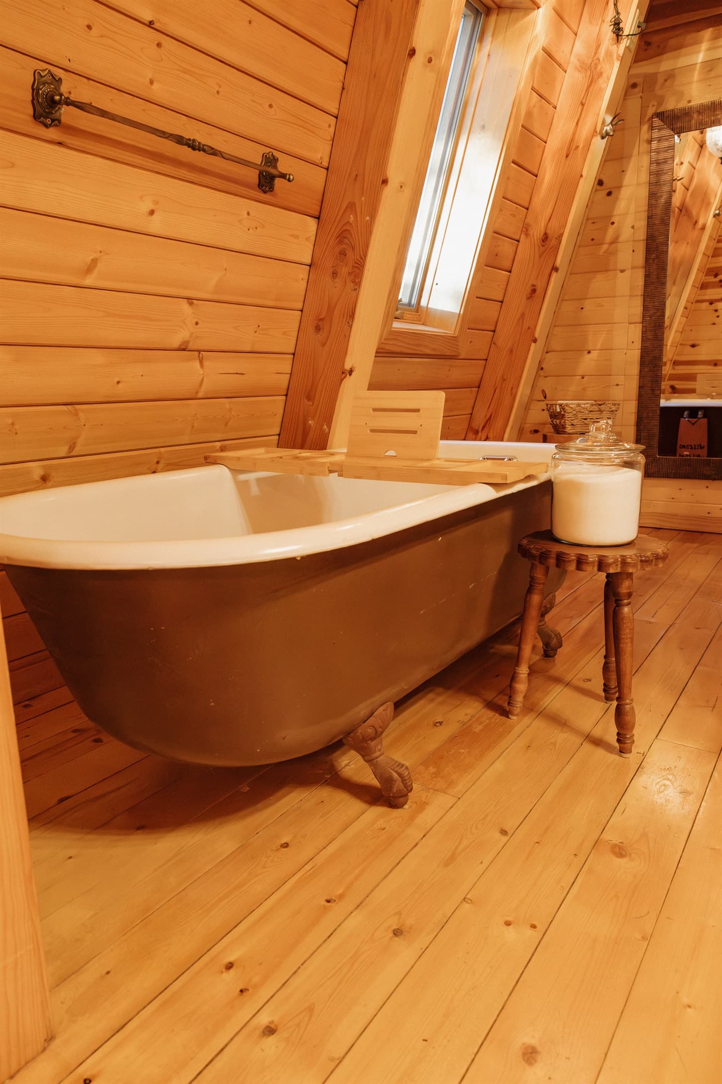 Soak in the clawfoot tub with complimentary bath salts beneath skylight views at Poppywood Pines. This luxurious gothic western Show Low A-frame offers spa-like relaxation after exploring White Mountains hiking trails, fishing, and outdoor adventures.