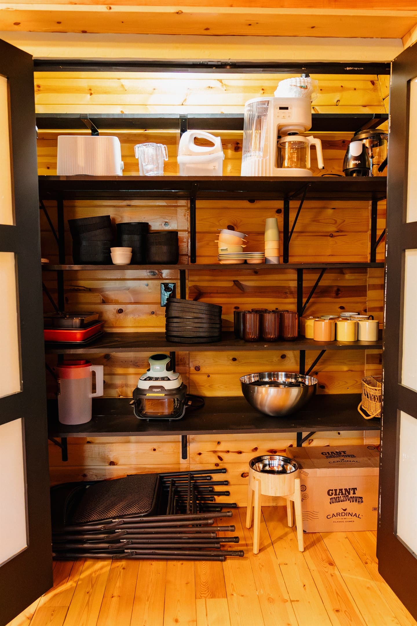 A well-stocked kitchen pantry at Poppywood Pines includes dishes, glassware, and cookware for family meals. This pet-friendly Show Low A-frame provides everything needed for your White Mountains vacation, from coffee makers to serving bowls and bakeware.