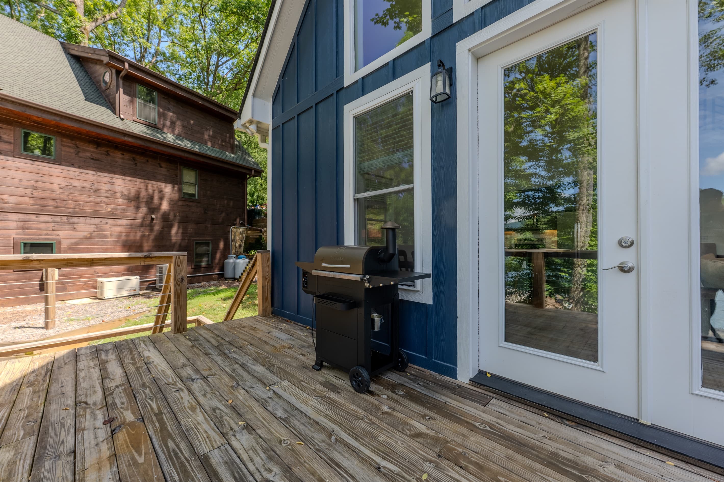 Main level- Deck with lake views, smoker, and outdoor dining