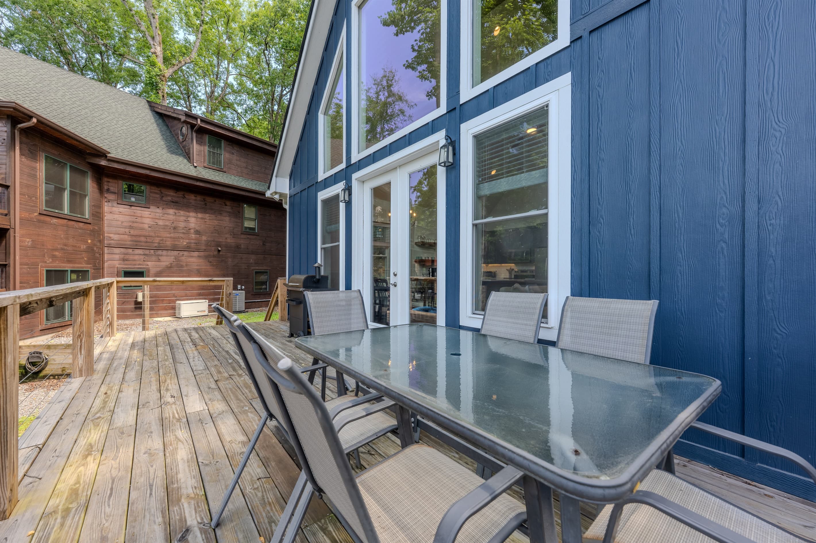 Main level- Deck with lake views, smoker, and outdoor dining