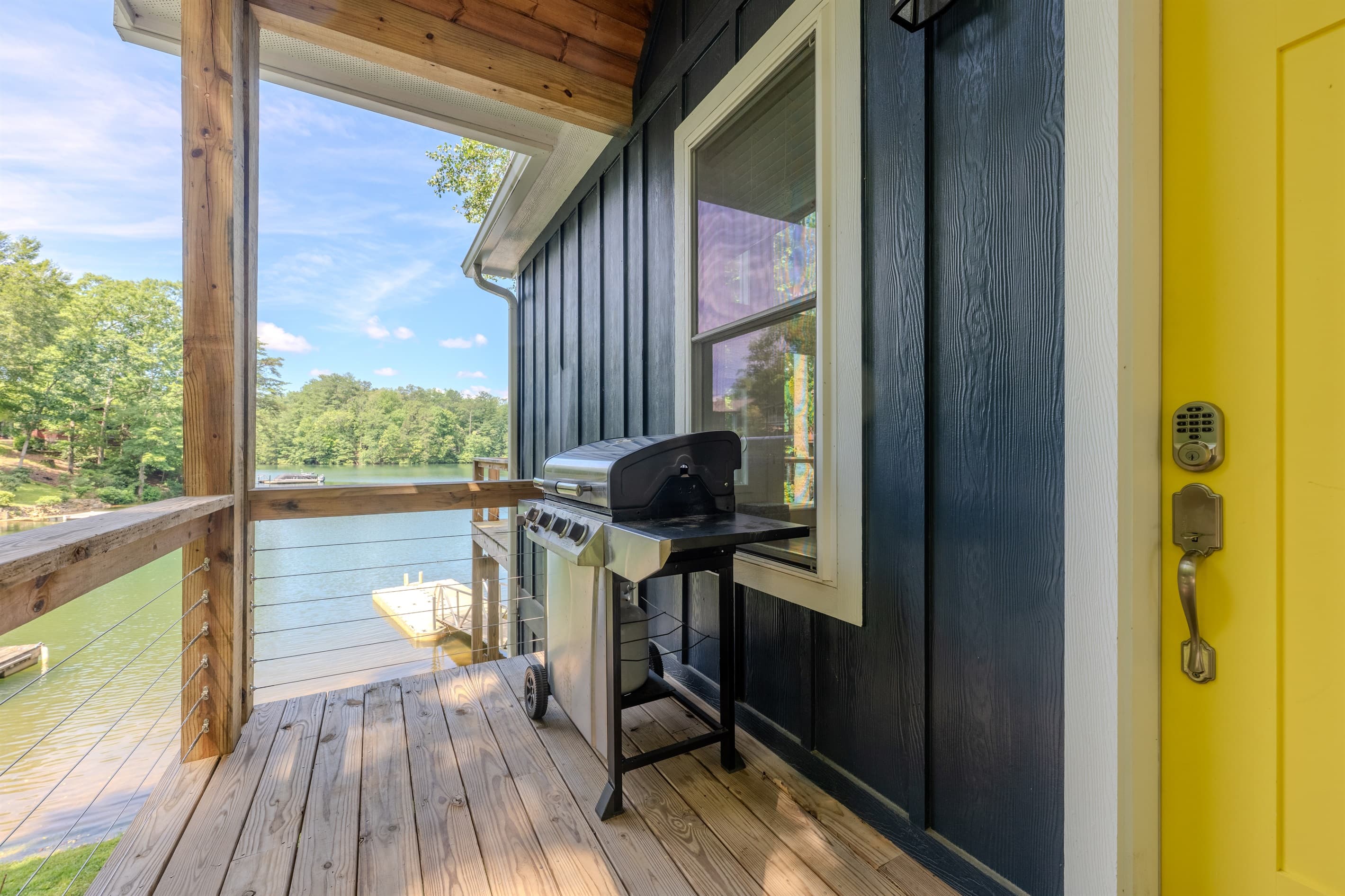 Main level- Deck with lake views, covered porch, and gas grill