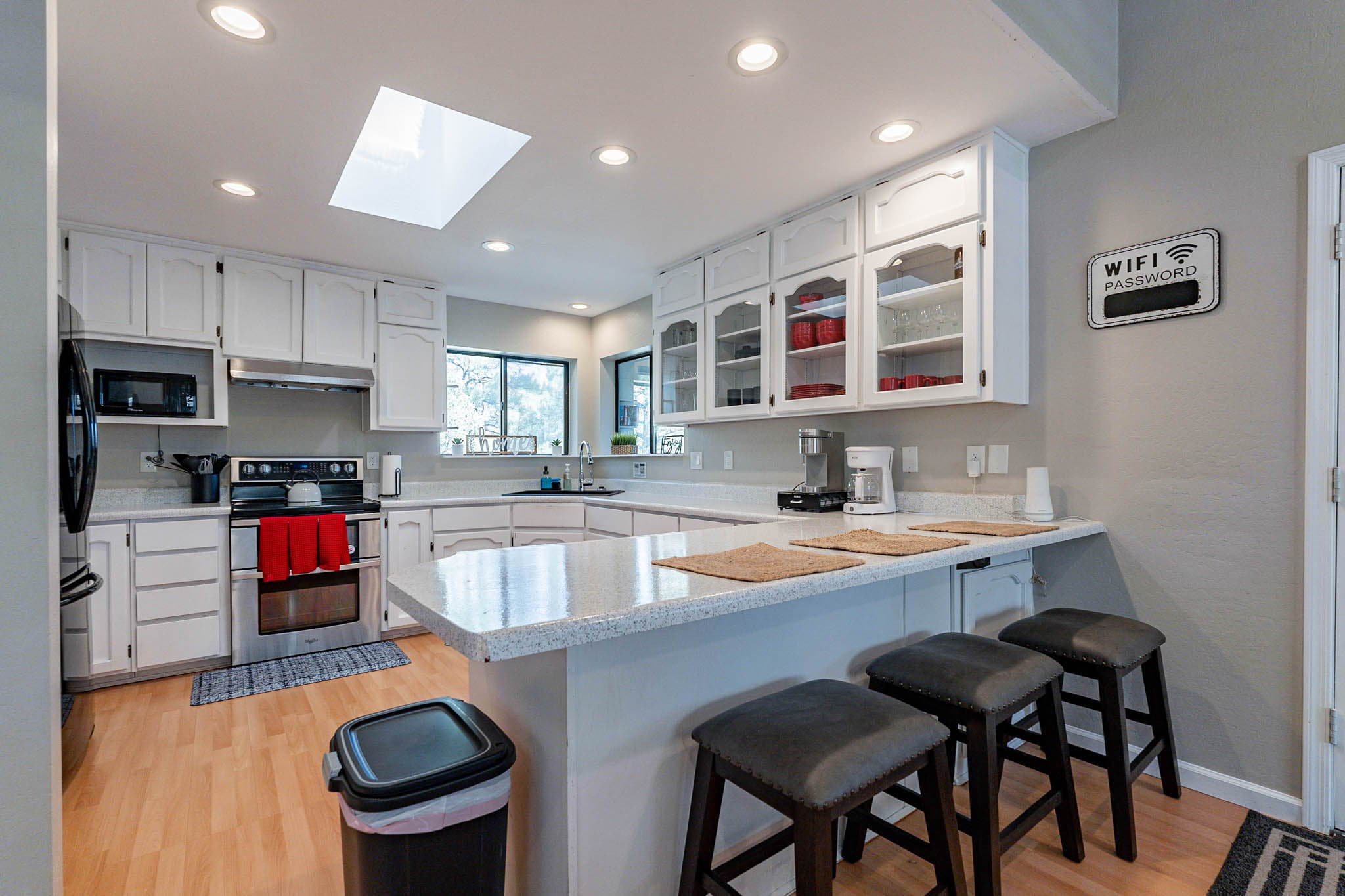 Well stocked kitchen with extra seating at the peninsula