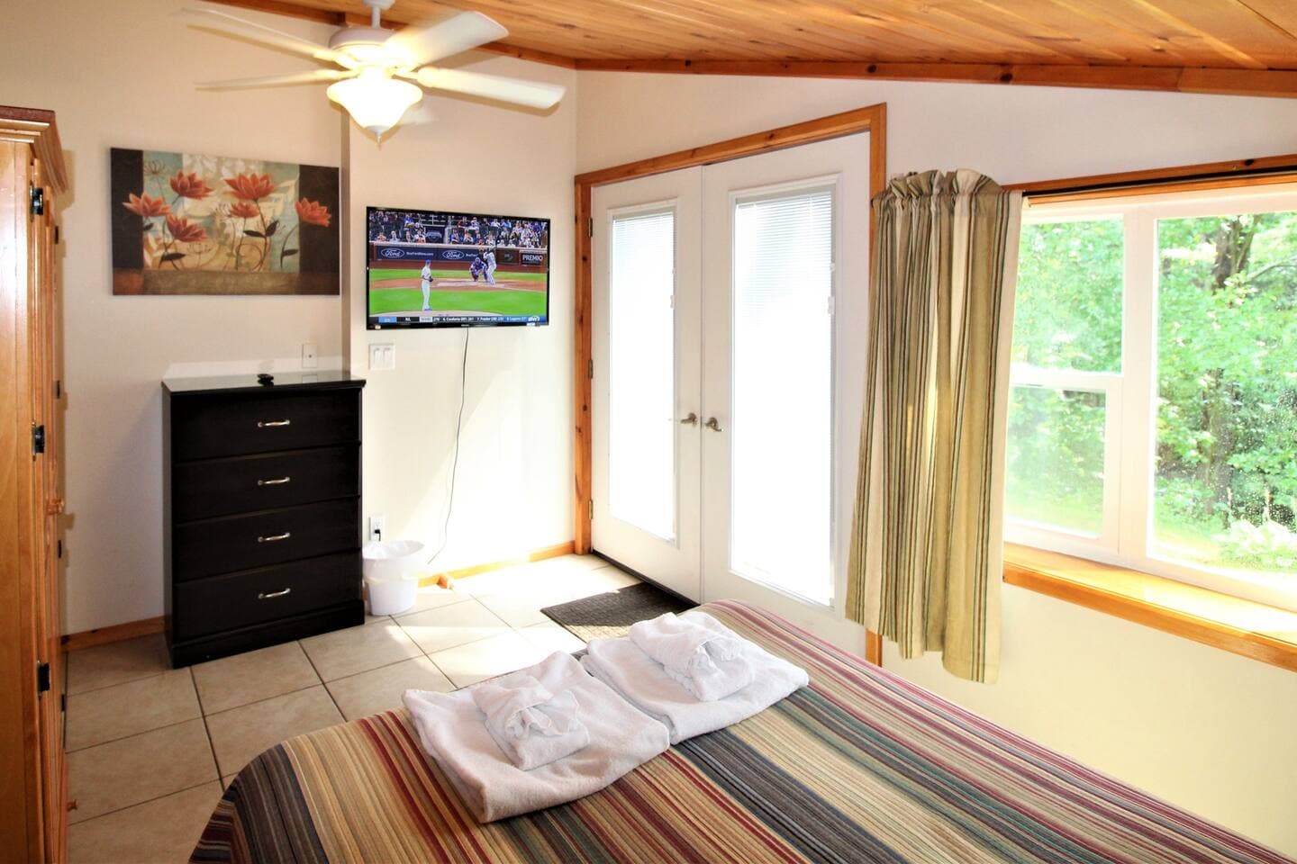 Bedroom #1 with full size bed, wet bar, views of the lake and a 43" (or larger) flat screen smart Roku TV