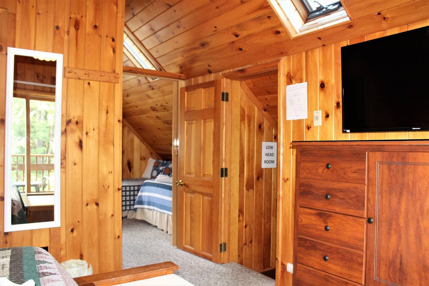 Entrance to bedroom #5 - railroad style access through bedroom #4 (king bedroom)Shown with folding door open.