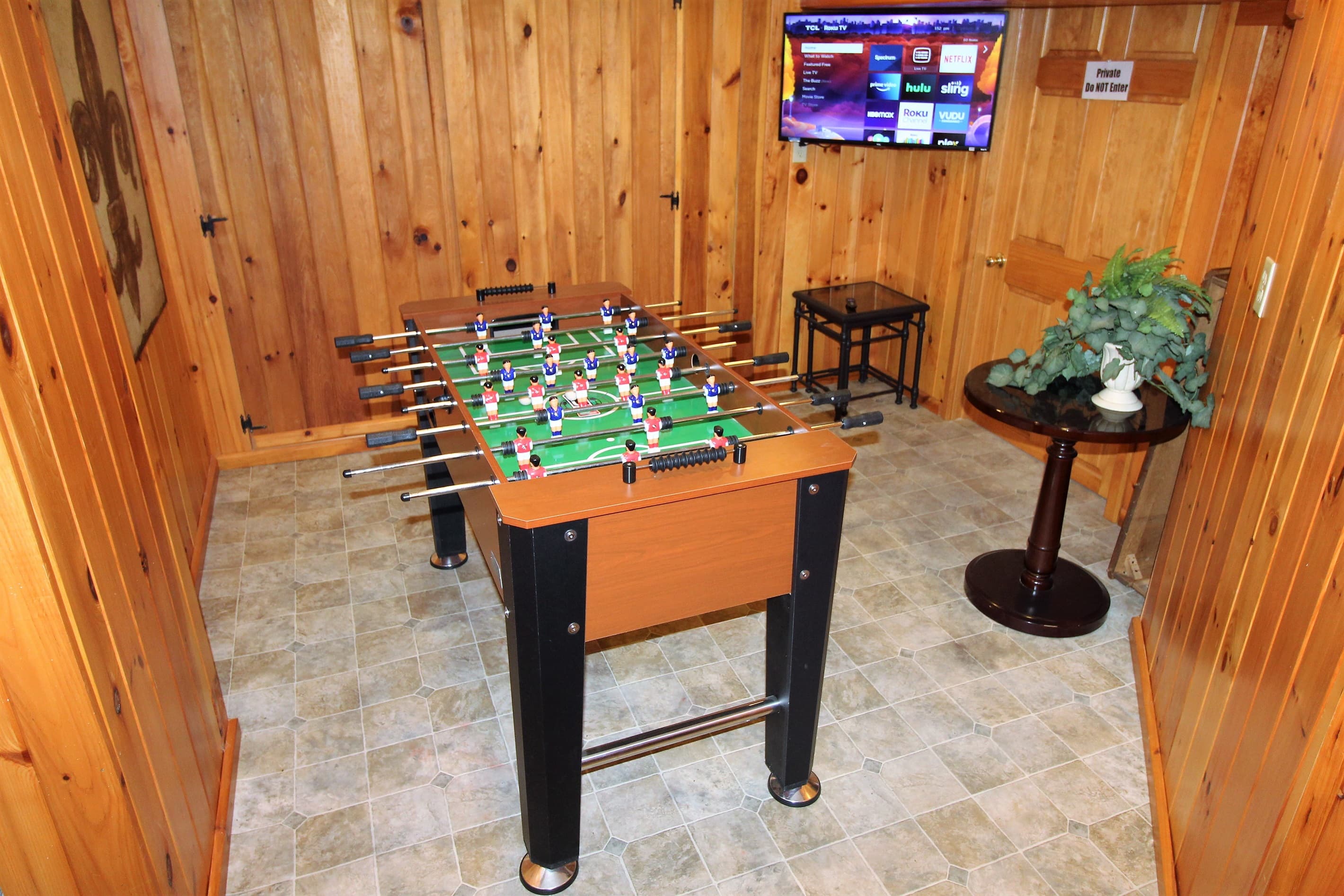 Game room with foosball table and Roku TV in the basement for some spirited competitions