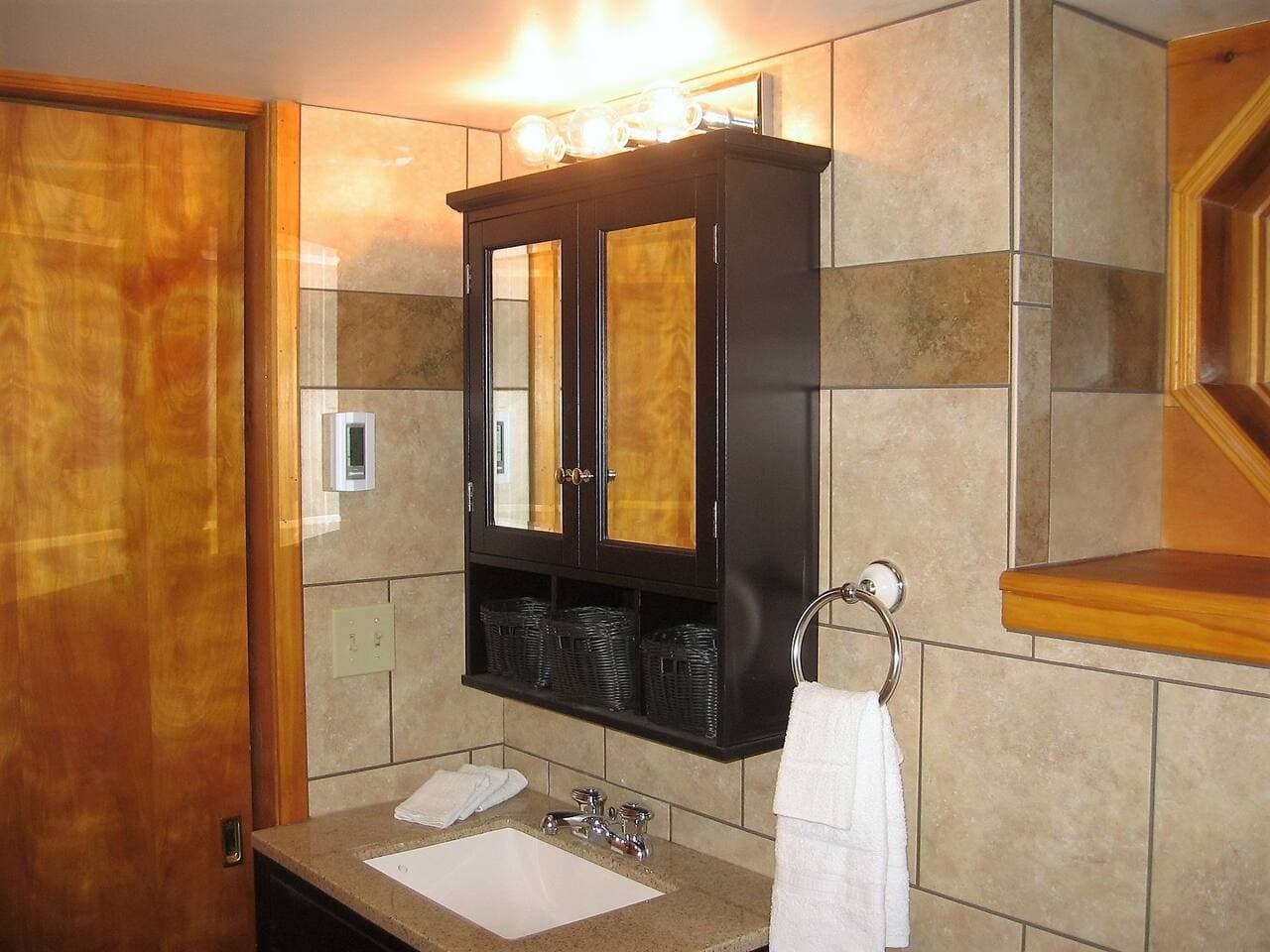 Modern tiled bath with heated floor in the downstairs king suite