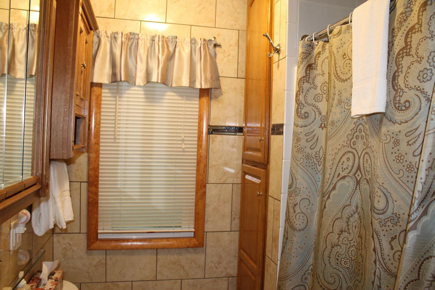 Fully tiled bathroom on the main floor with stall shower