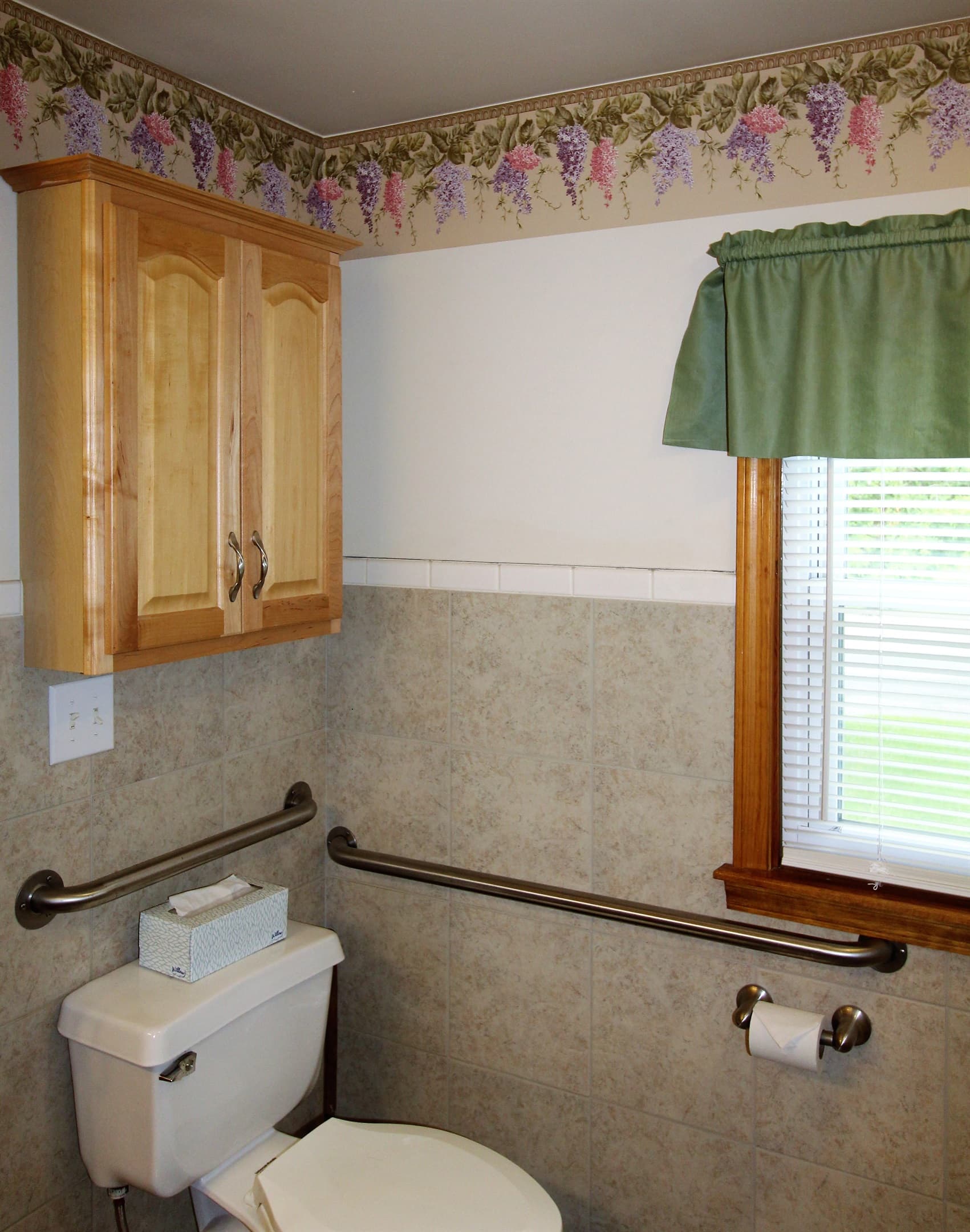 Grab bars around the toilet in the Handicapped accessible bath