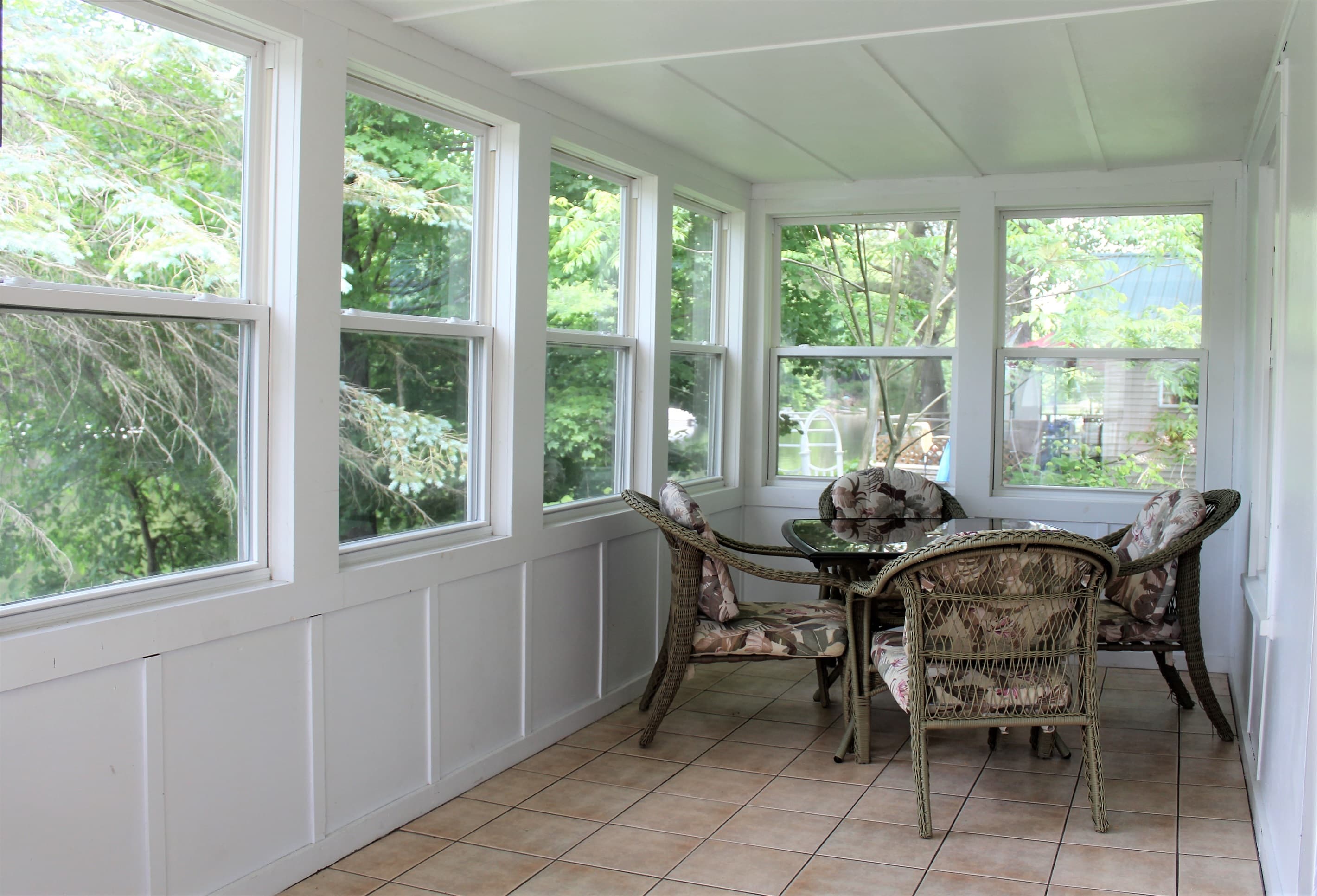 Three season sunporch for morning coffee or afternoon cocktails and conversation, or the perfect place to relax during a rain delay at the park