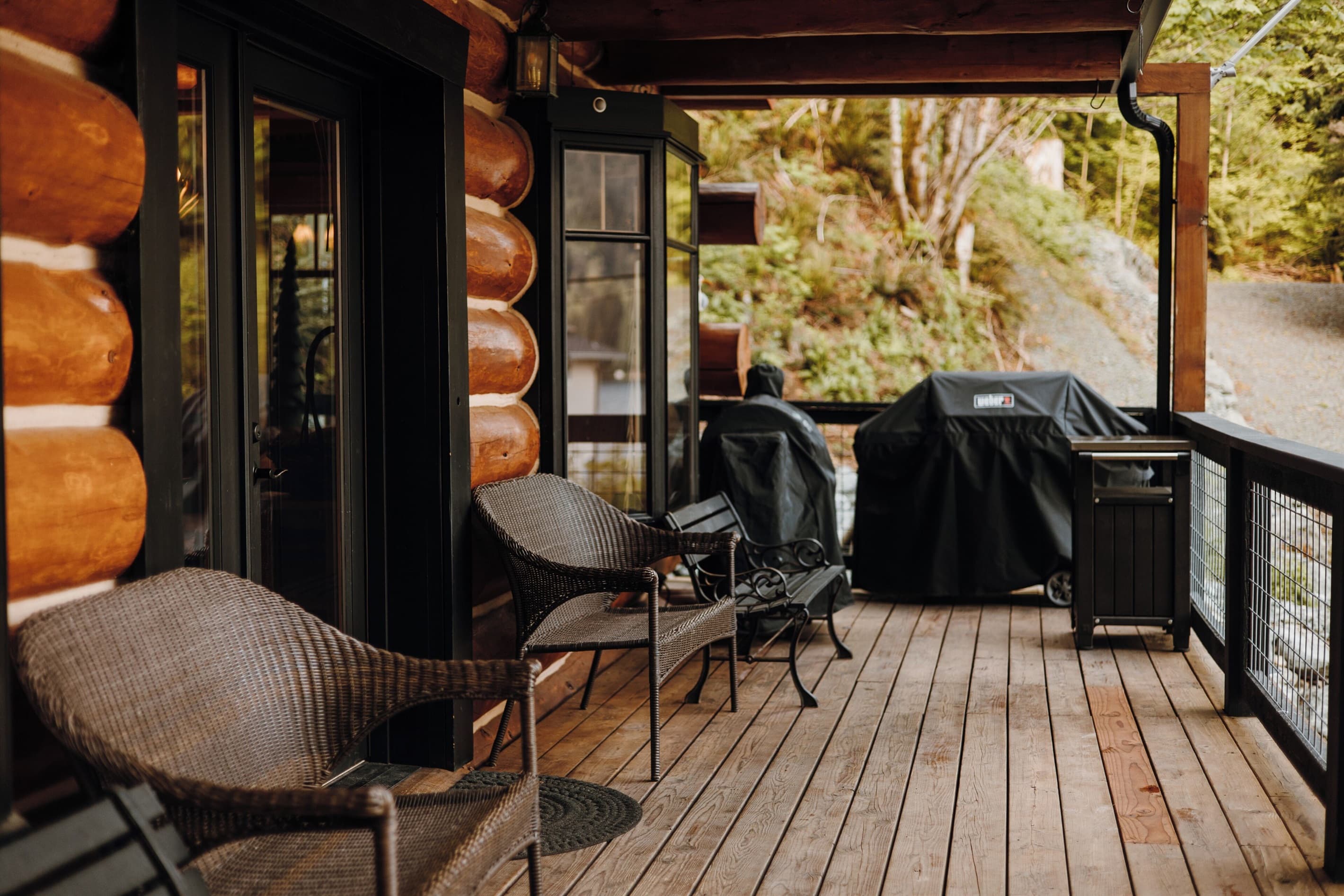 The main deck offers stunning views of the lake, complete with a barbecue grill and seating.