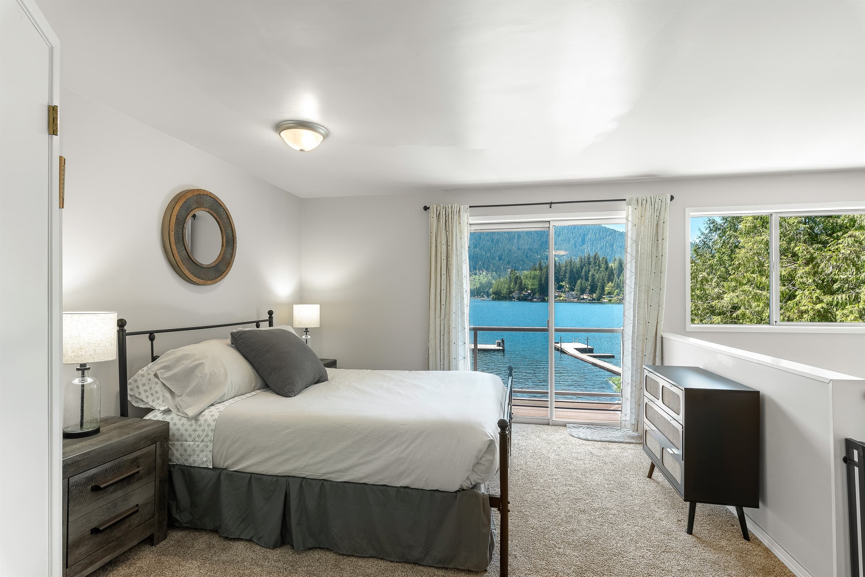 Upper level queen bed with sliding door to the upper balcony.