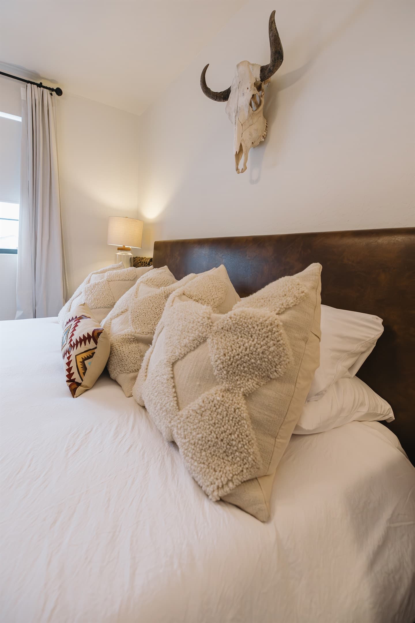 Plush king bed with cozy layers and warm mountain style—designed for restful nights and slow mornings. A romantic Pinetop retreat ideal for couples or families unwinding after outdoor adventures.