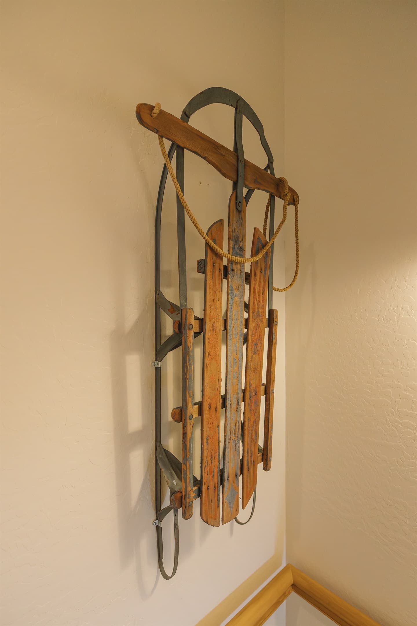 Vintage mountain sled wall art adds rustic charm and nostalgic cabin character—one of many thoughtful details that make this cozy White Mountains retreat feel warm, welcoming, and unforgettable.