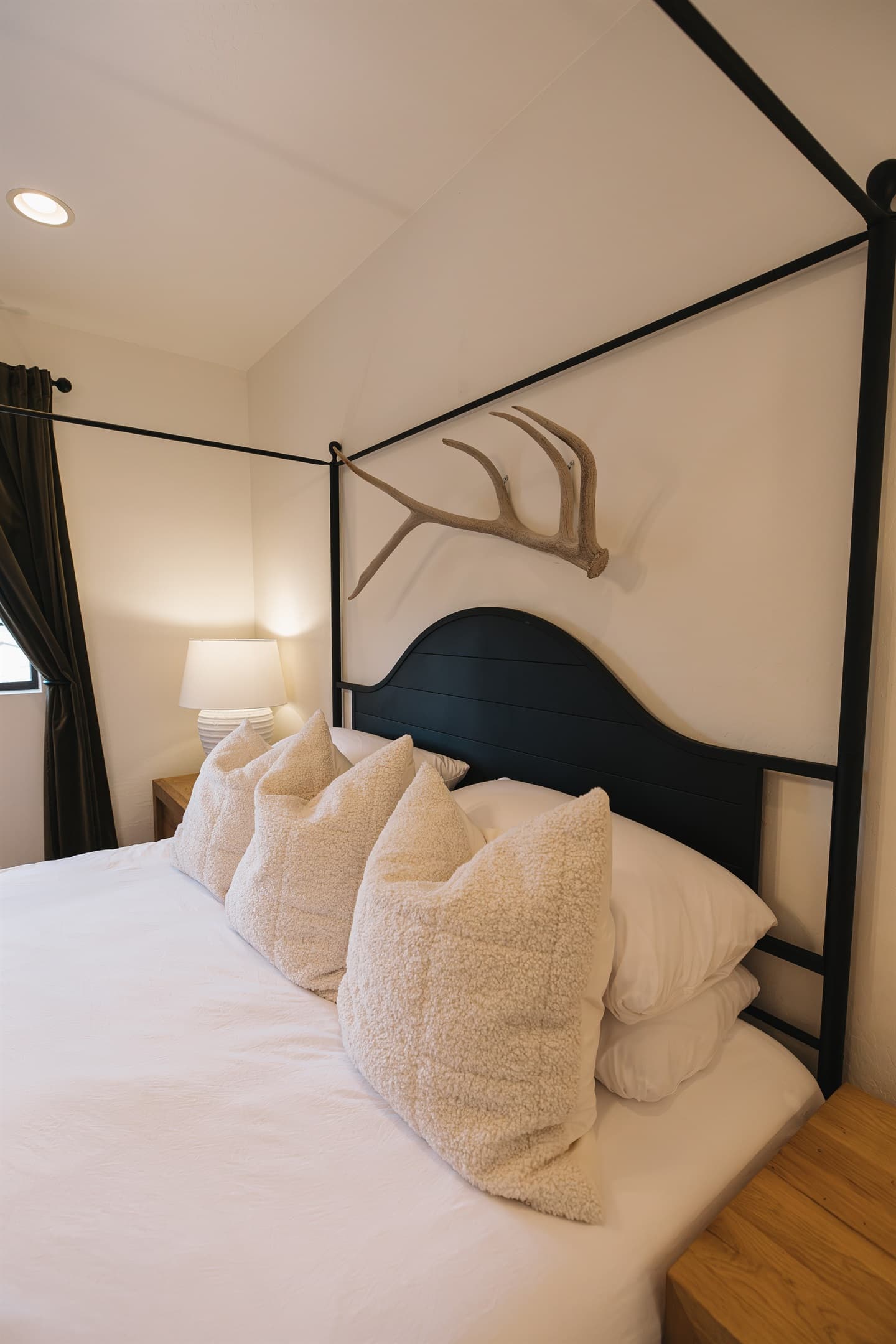 Serene king bedroom with plush linens, cozy pillows, and rustic mountain accents—designed for deep rest after hiking, skiing, or exploring Arizona’s White Mountains.