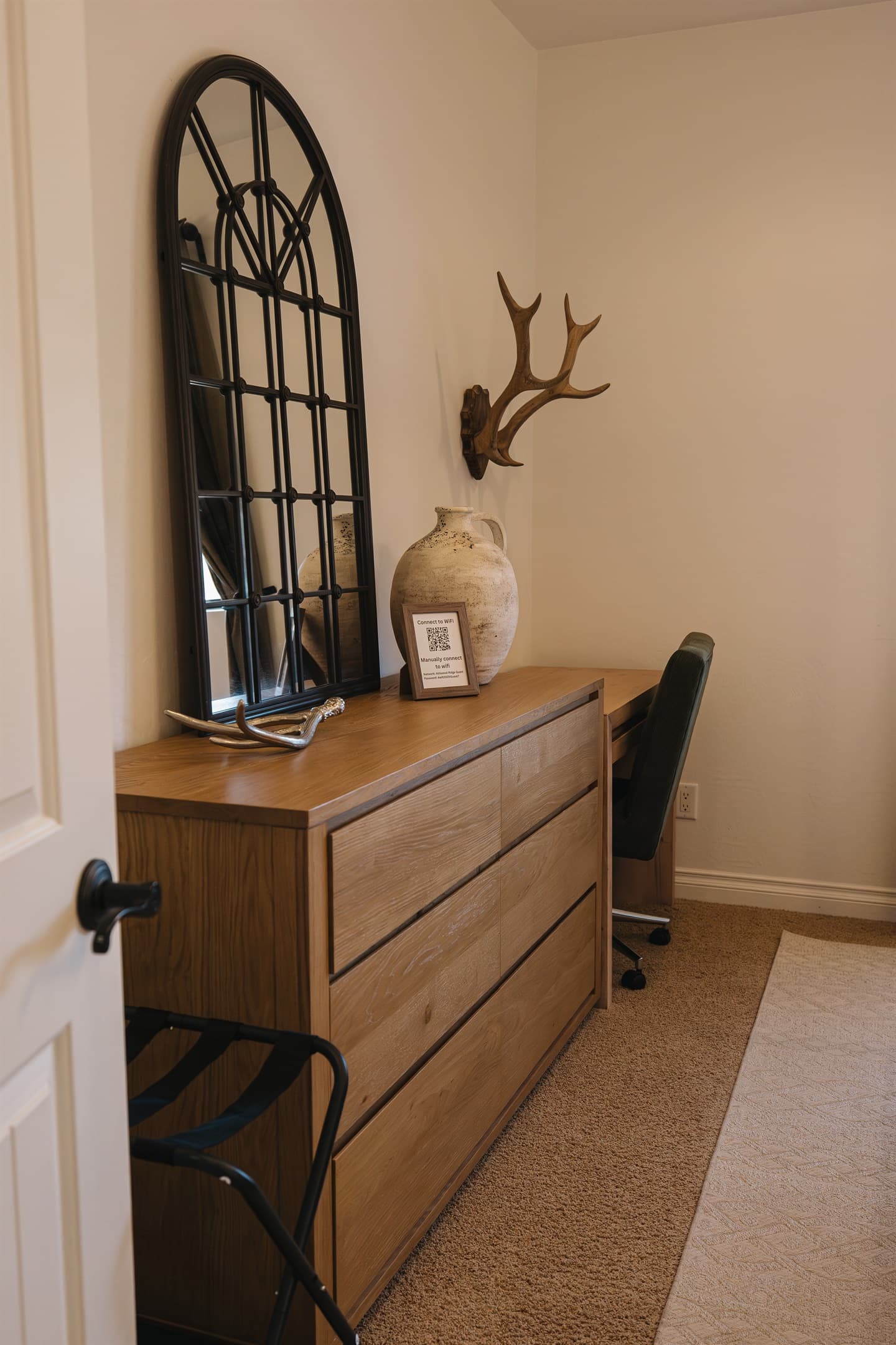 Quiet workspace with dresser storage, cozy desk chair, and warm cabin styling—perfect for remote work, journaling, or unwinding during your White Mountains getaway.