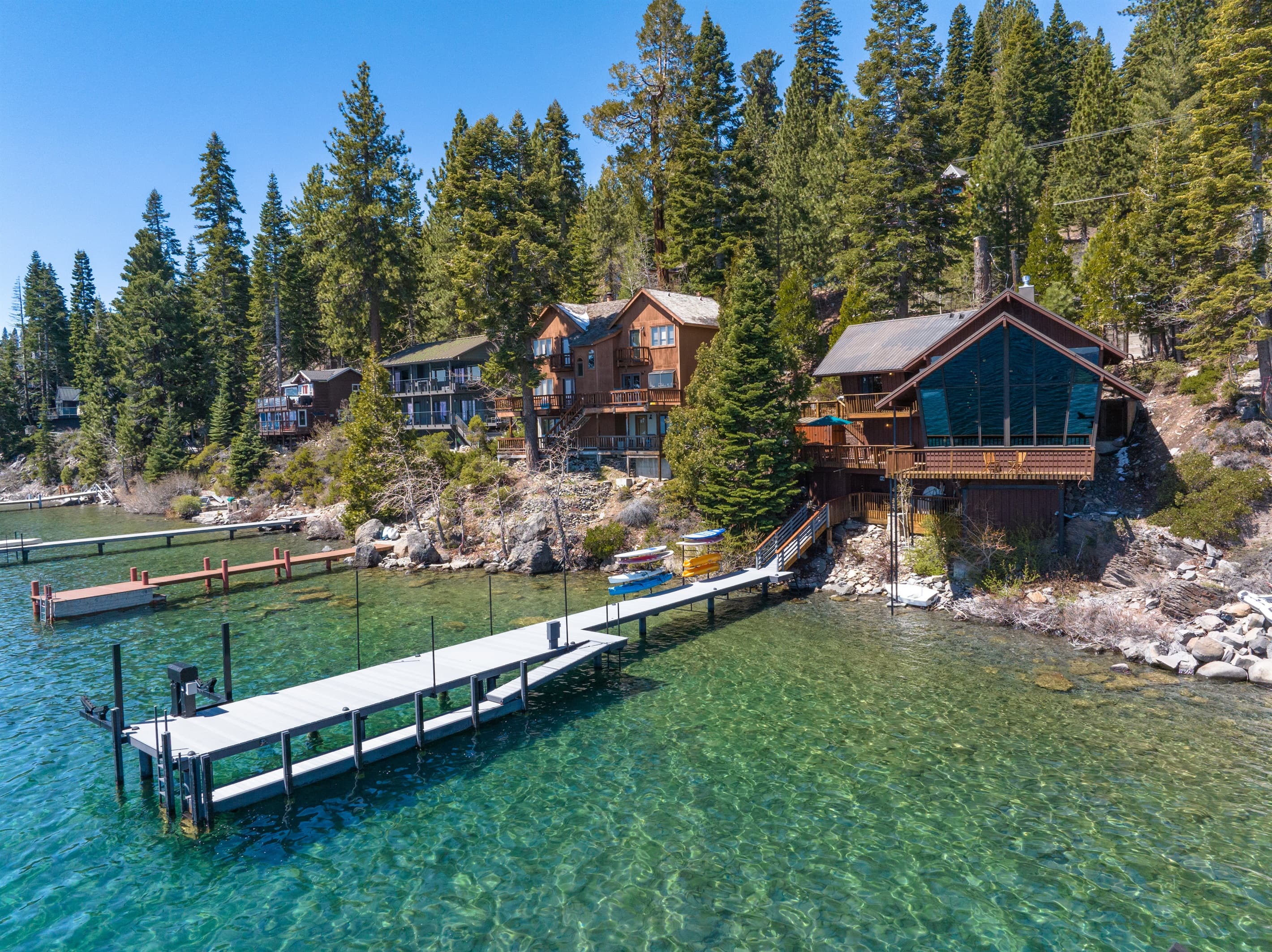 The private pier offers direct access to the lake, with kayaks and paddleboards available for guests to enjoy.