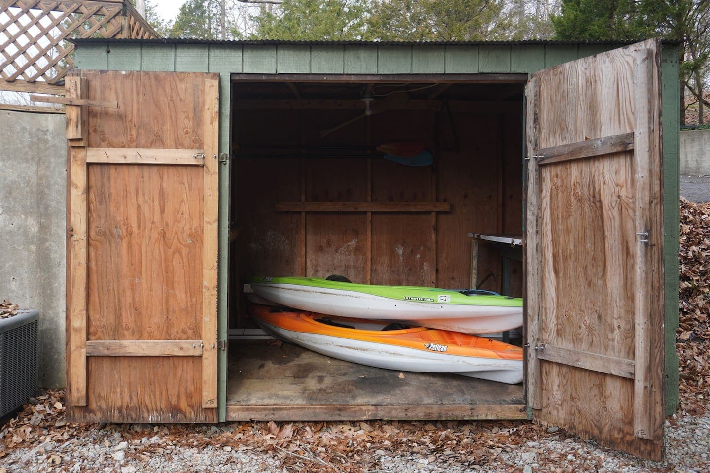 Two kayaks stored in a shed.