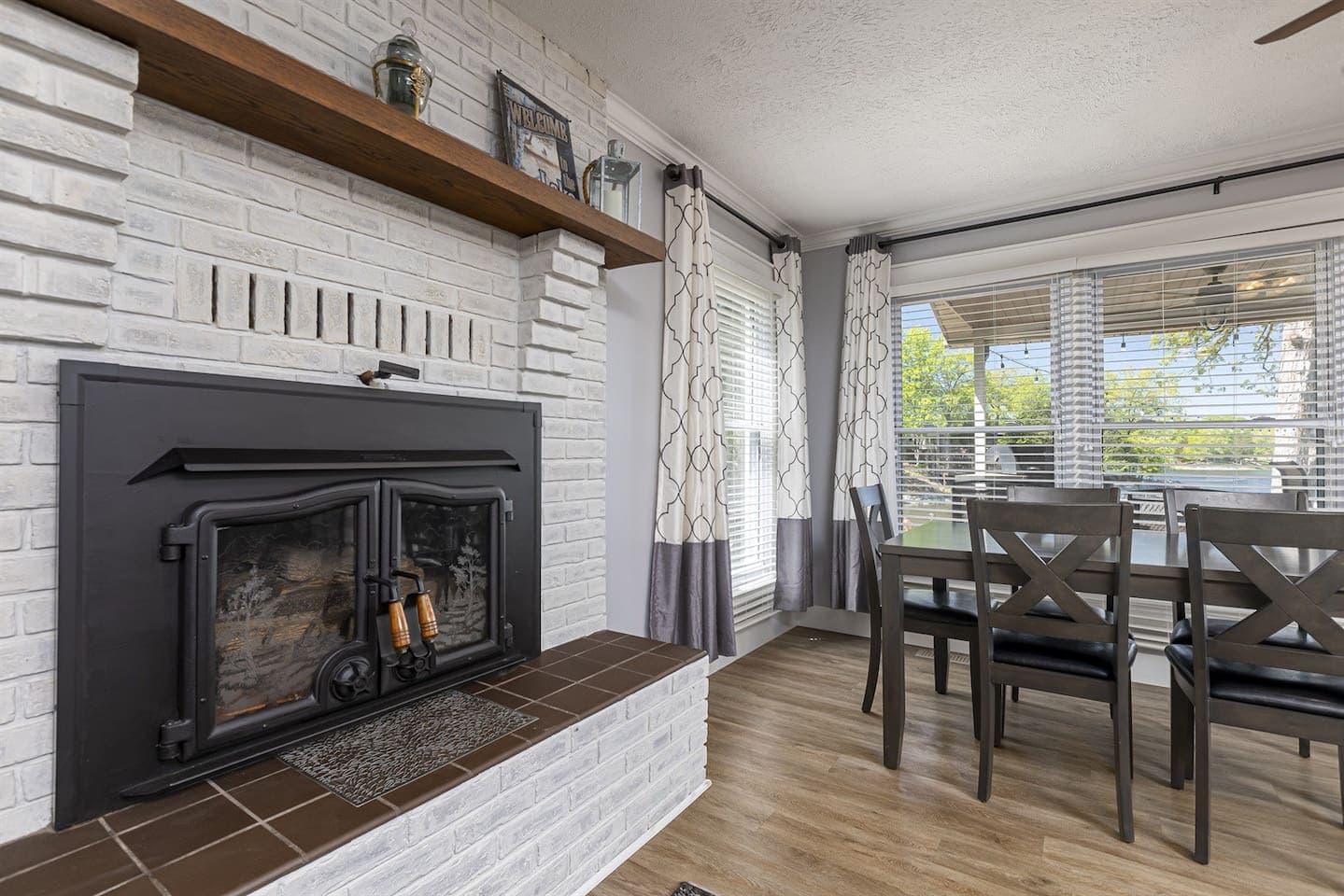 A cozy living room with a fireplace and a dining table.