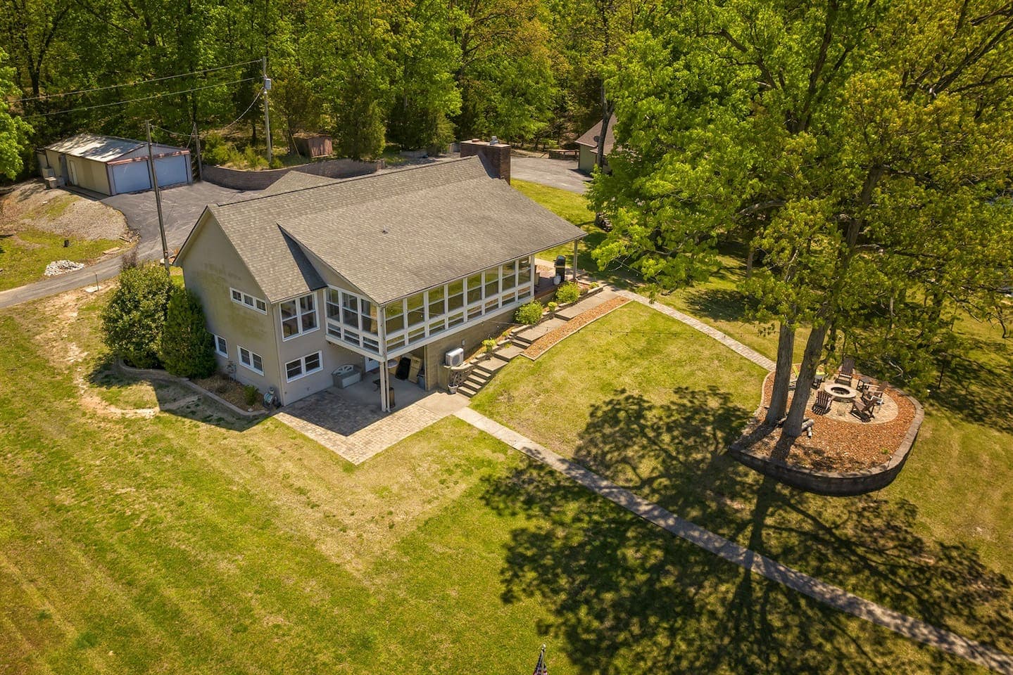 A cozy home nestled in the woods, seen from above.