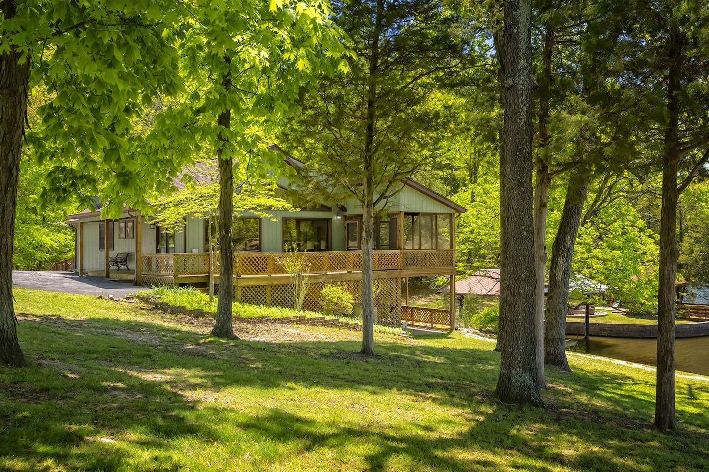A house nestled amidst lush green trees and grass.
