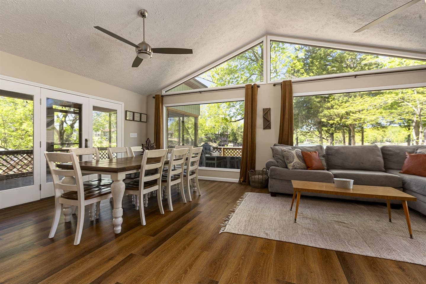Spacious living room with hardwood floors and ceiling fan.