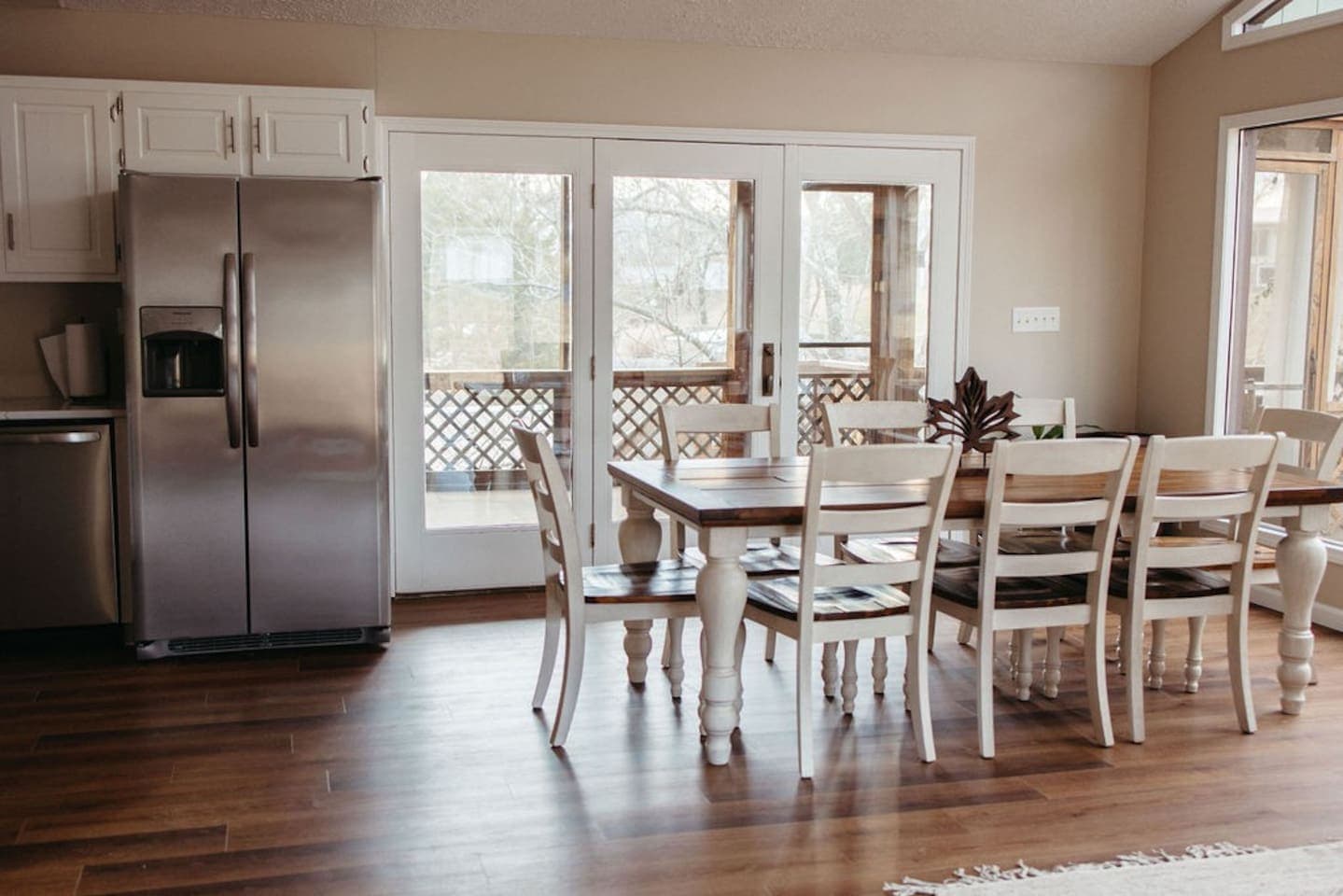 A cozy kitchen and dining room with beautiful hardwood floors.