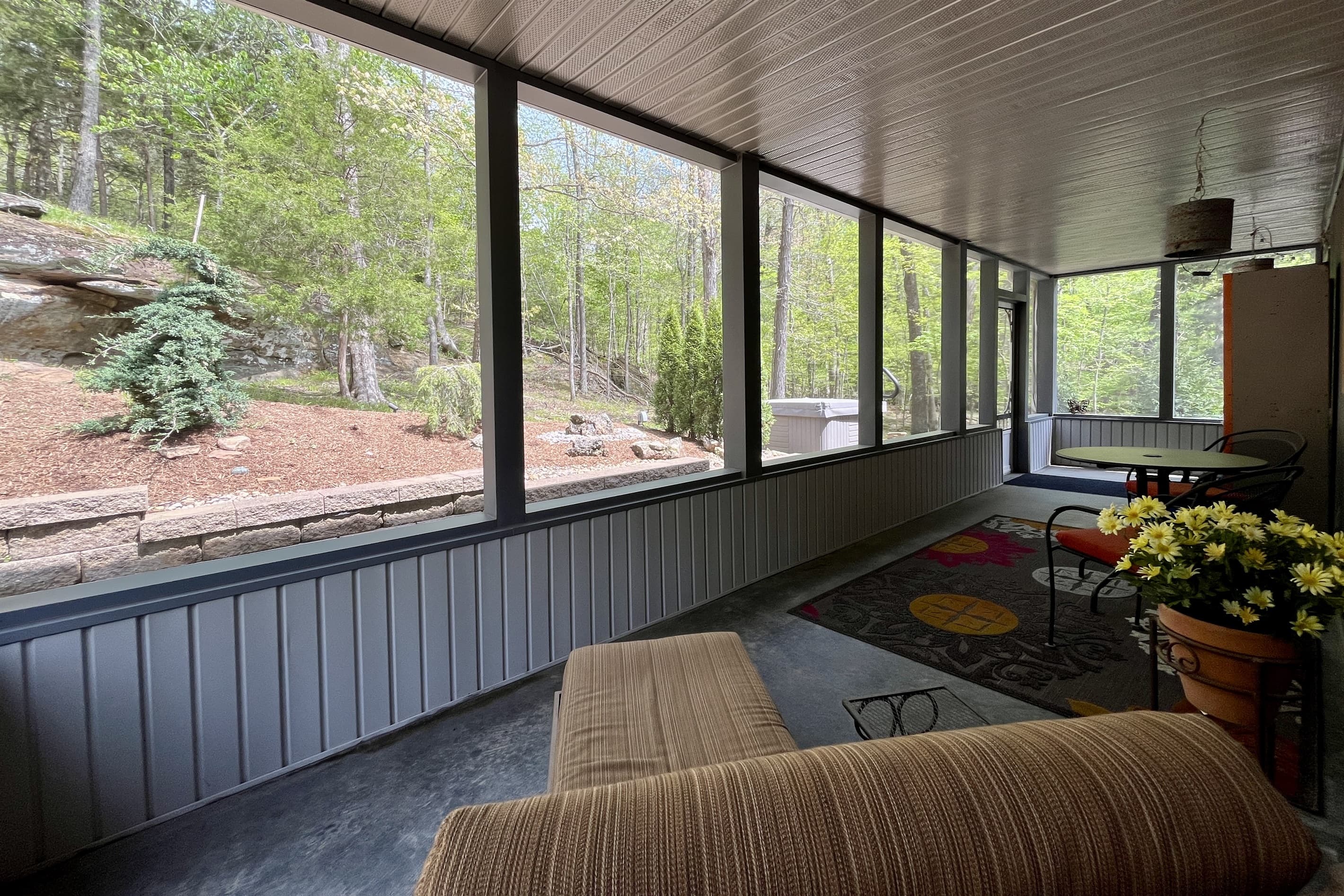 Covered porch overlooks woods