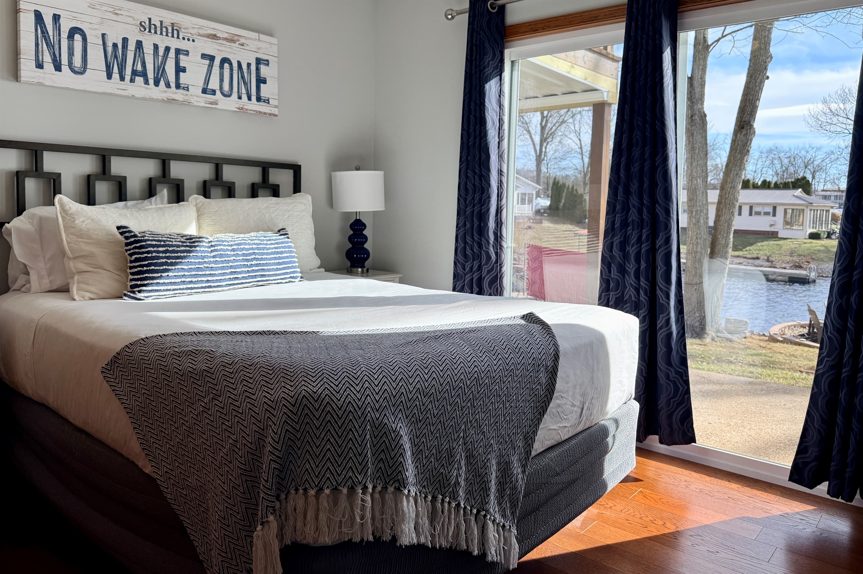 Queen bed with walkout patio overlooking the lake