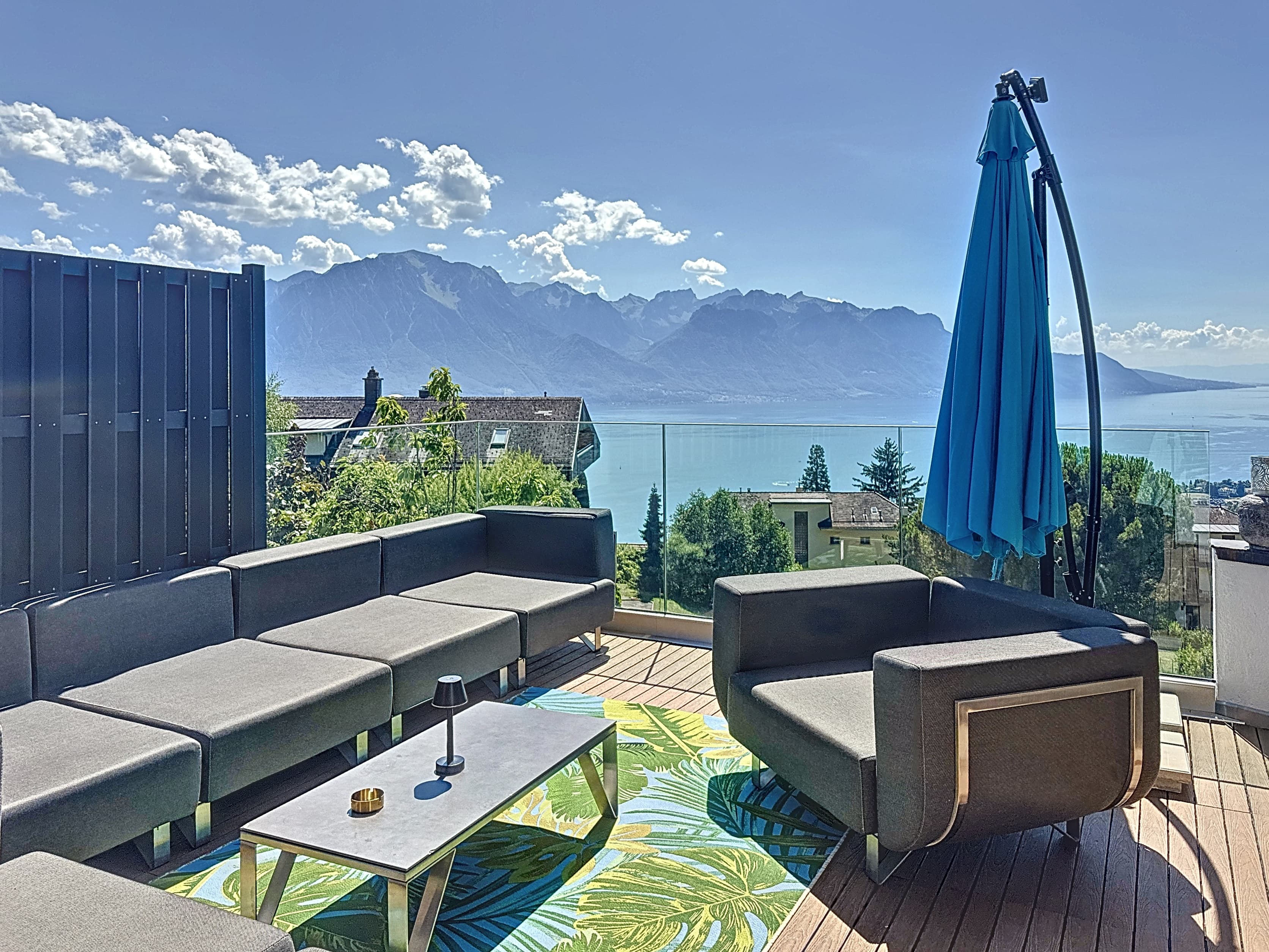 Ground-floor terrace with kitchen, BBQ, and pergola. Views of the mountains and Lake Geneva.