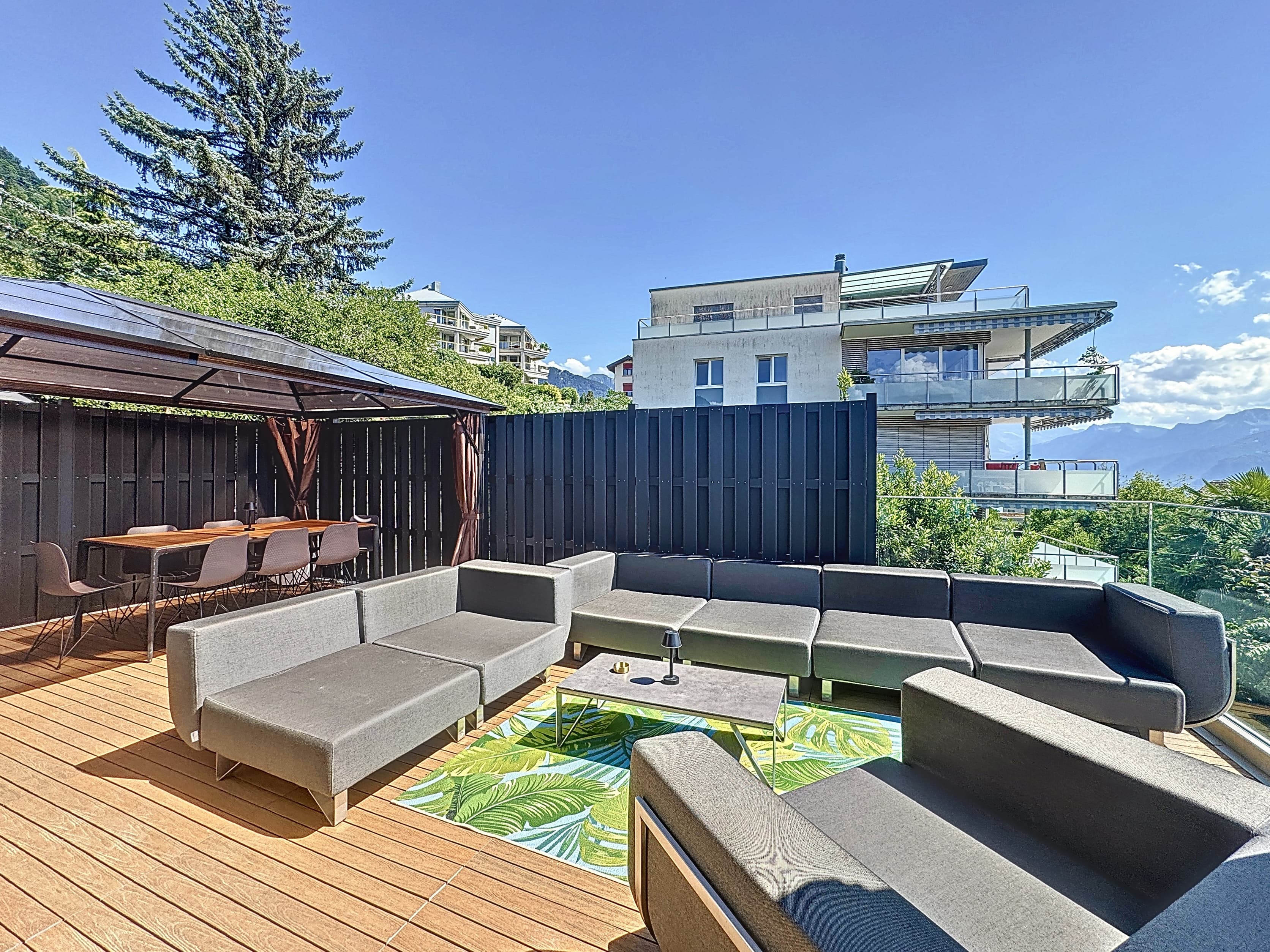Ground-floor terrace with kitchen, BBQ, and pergola. Views of the mountains and Lake Geneva.