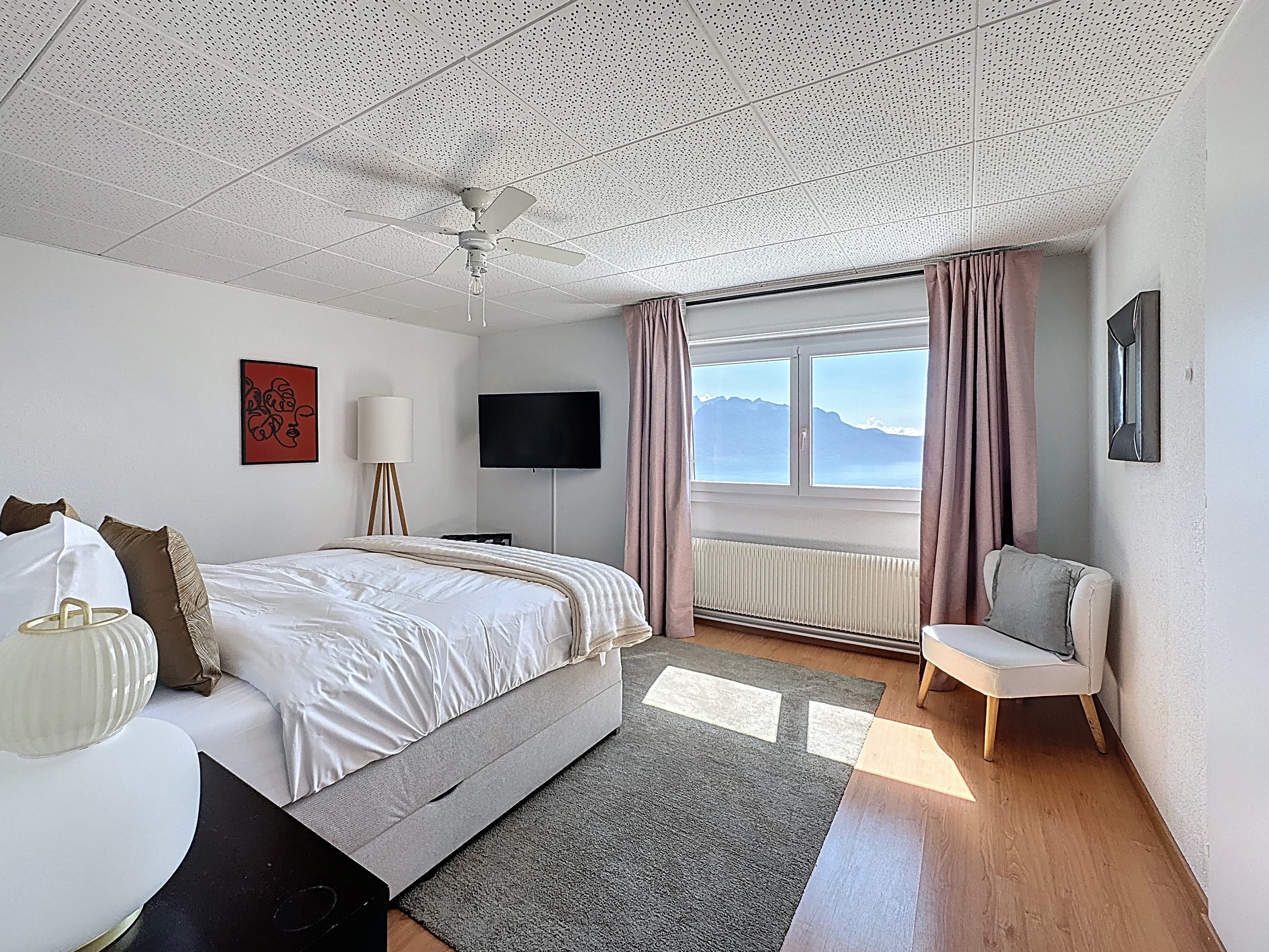 Master bedroom with view of the mountains and Lake Geneva on the 1st floor