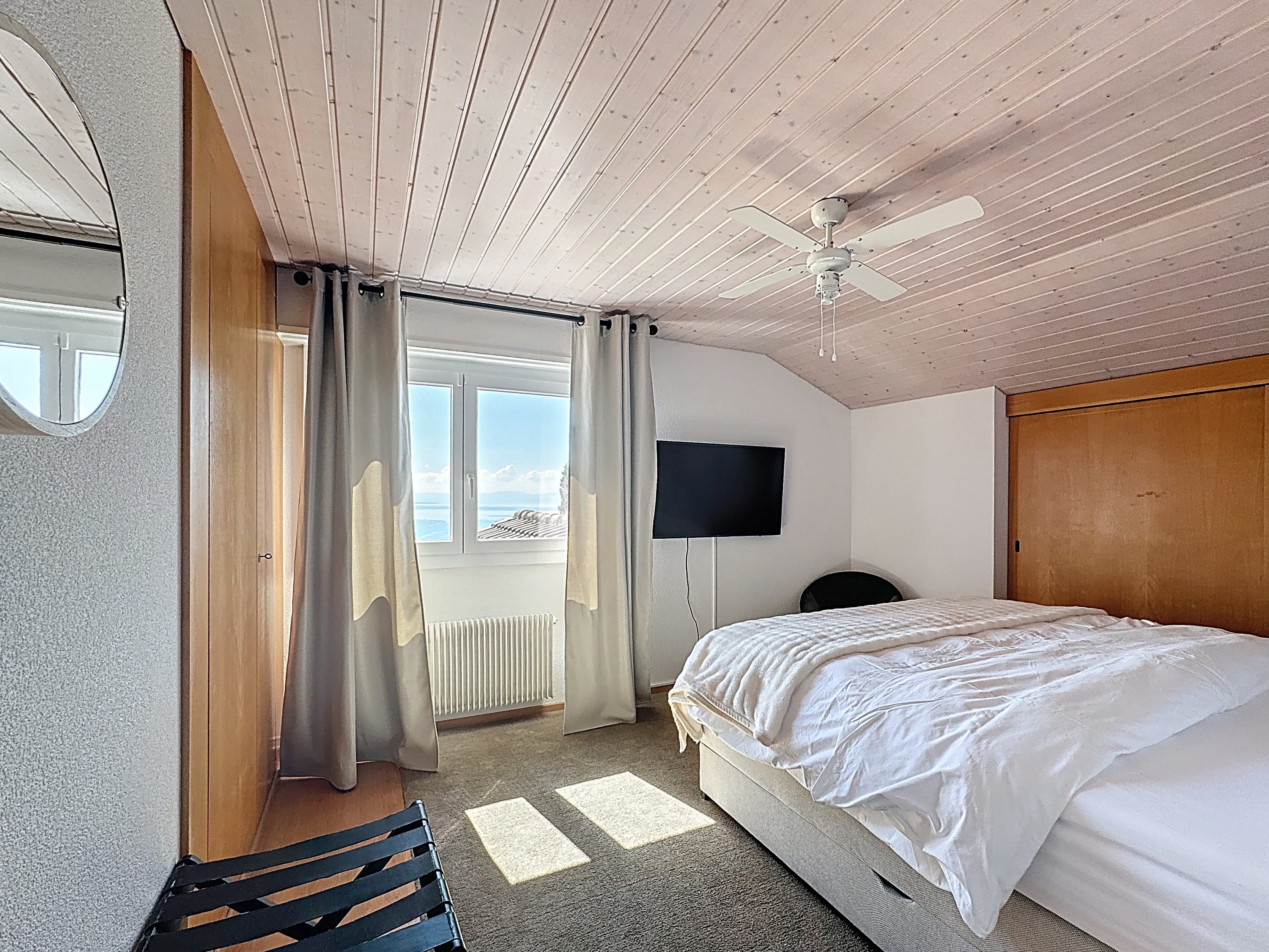 Master bedroom with view of the mountains and Lake Geneva on the 1st floor